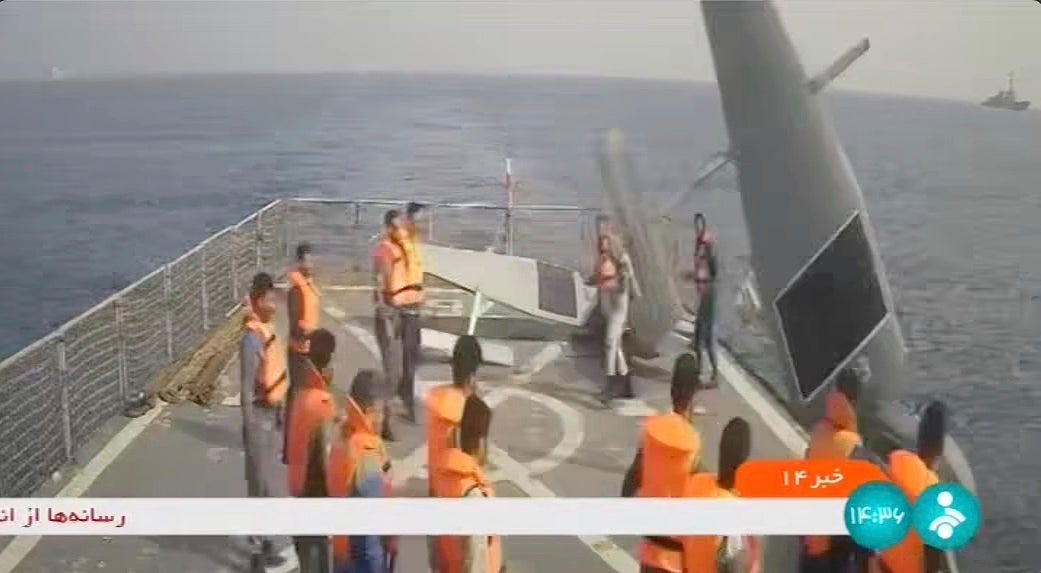 In this frame grab from Iranian state television, Iranian navy sailors throw an American sea drone overboard in the Red Sea on Thursday