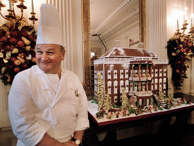 <p>Roland Mesnier shows off the White House gingerbread house in 2002 </p>