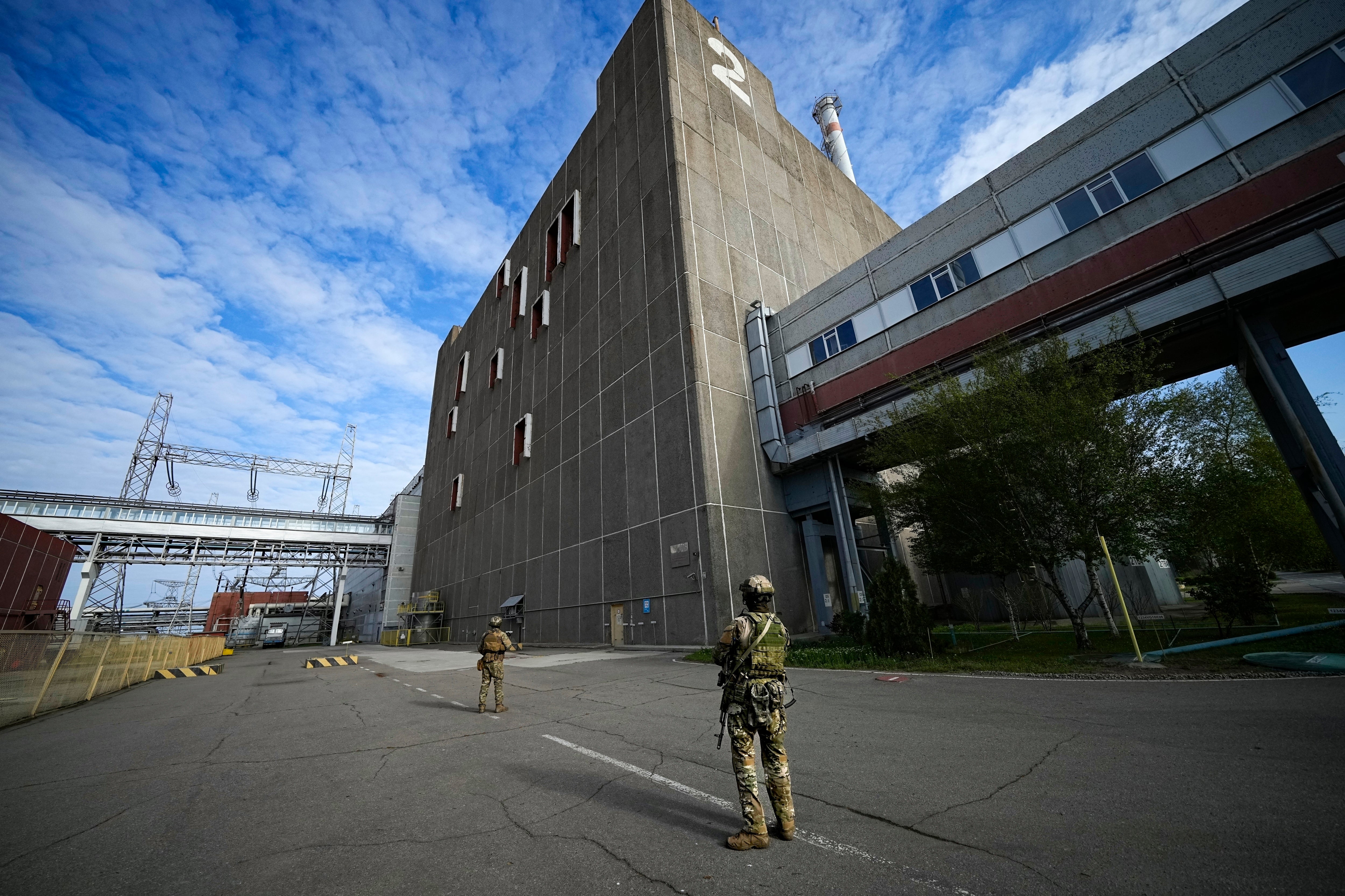 Russian servicemen guard an area of the Zaporizhzhia Nuclear Power Station