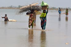 Pakistan breaches lake to help save city from flooding as death toll climbs to 1,300