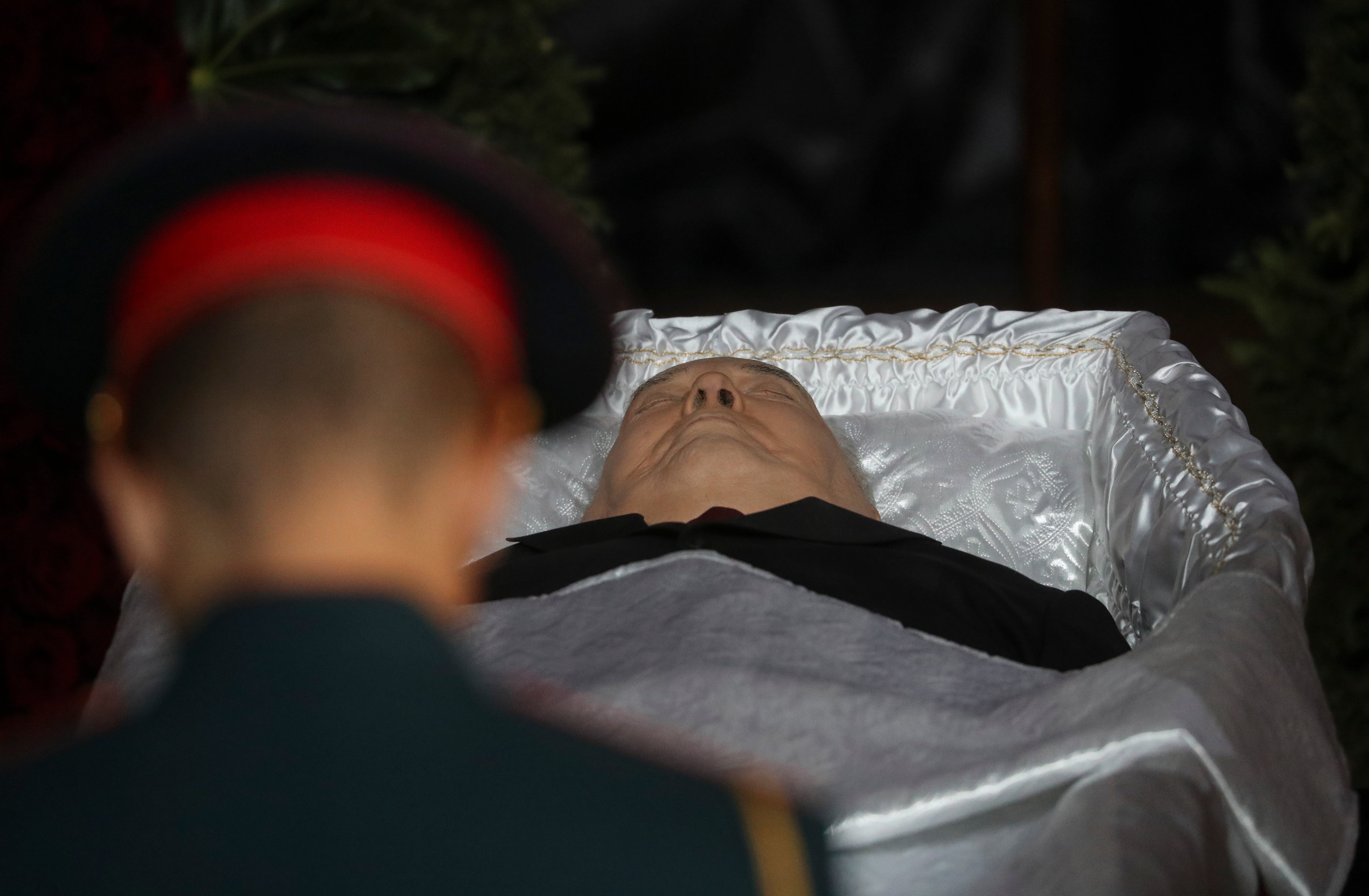 A guard stands over the body of the former Soviet leader