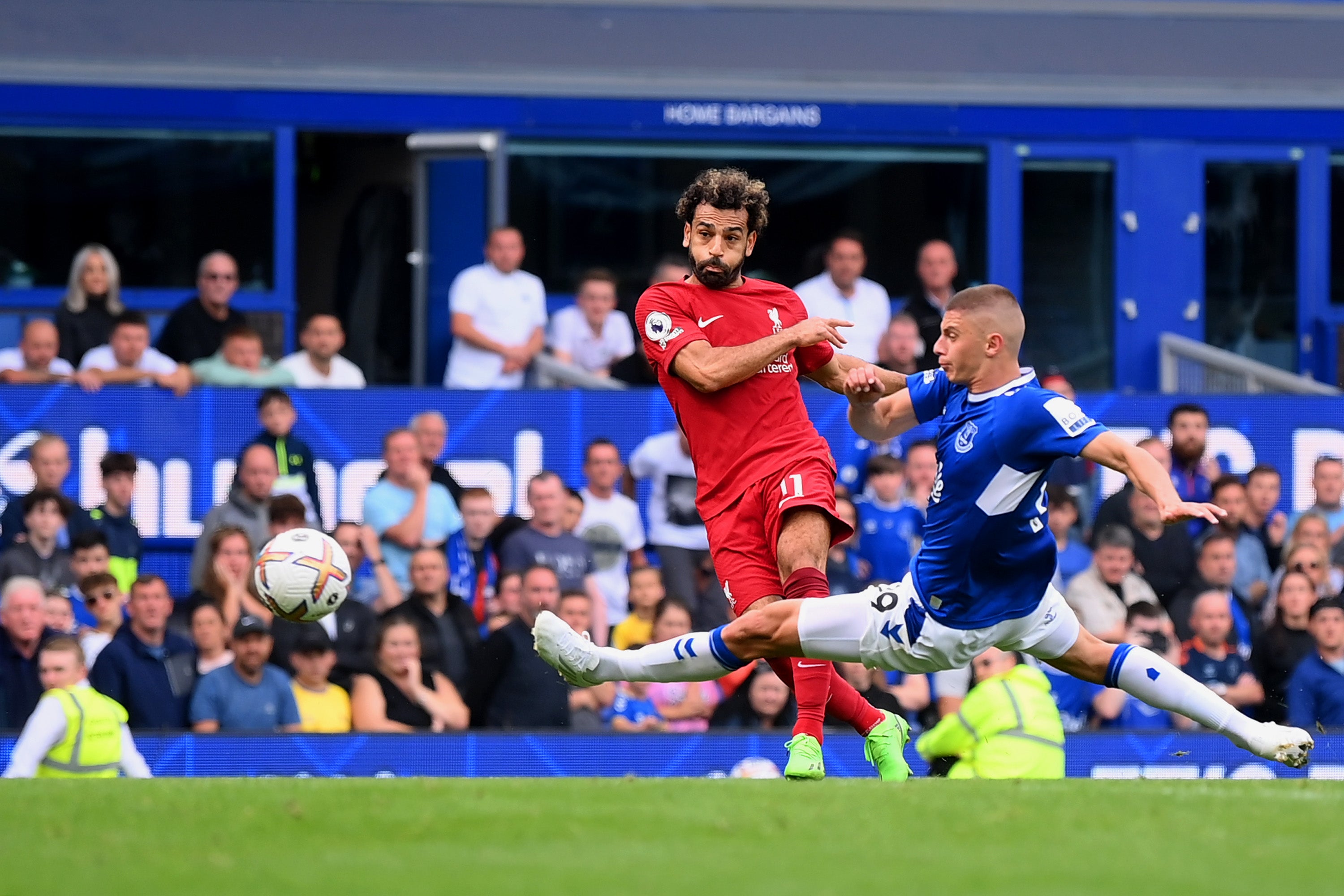 Mohamed Salah shoots past Vitaliy Mykolenko but his effort hits the post