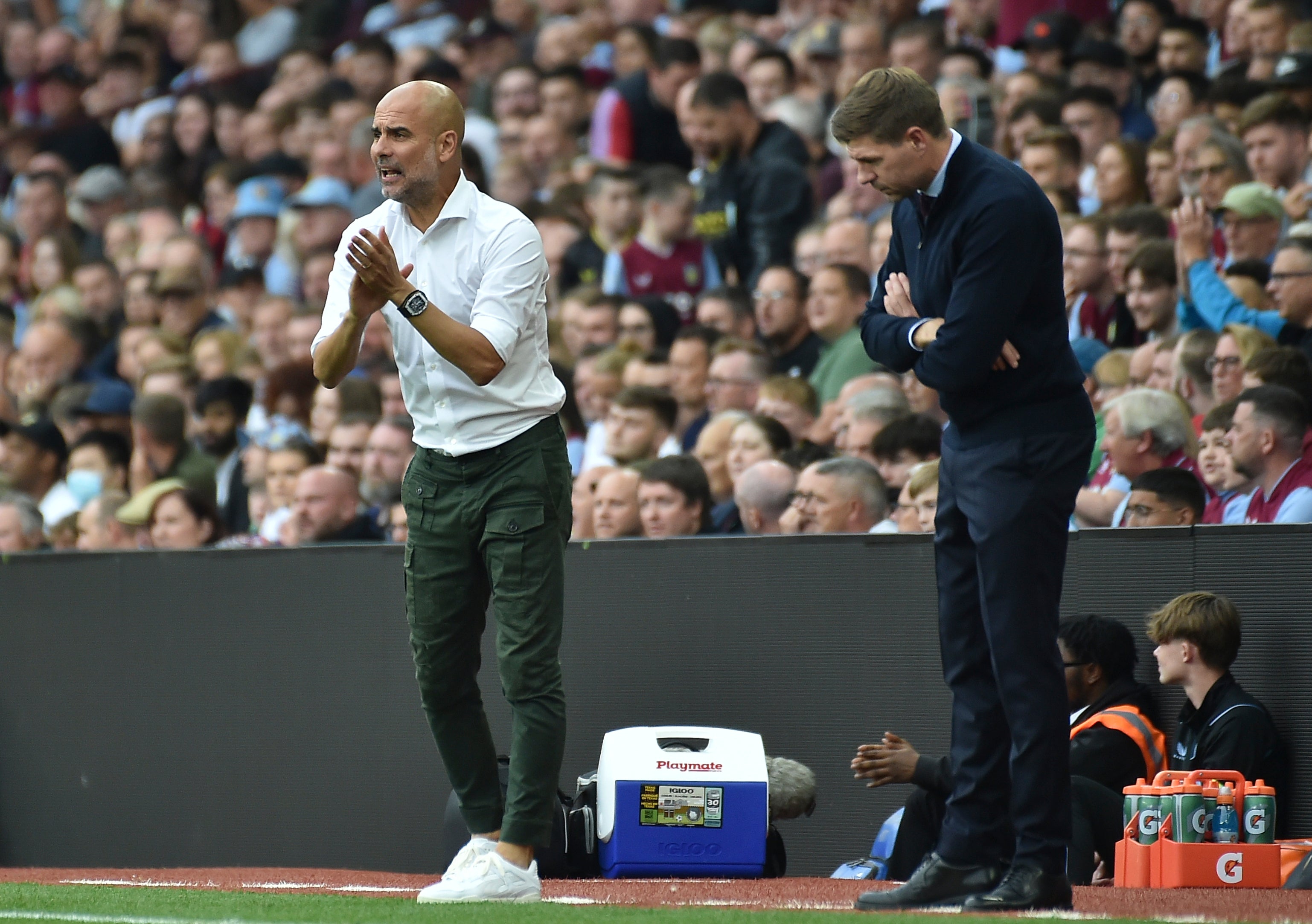 Manchester City's head coach Pep Guardiola, left, and Aston Villa's head coach Steven Gerrard