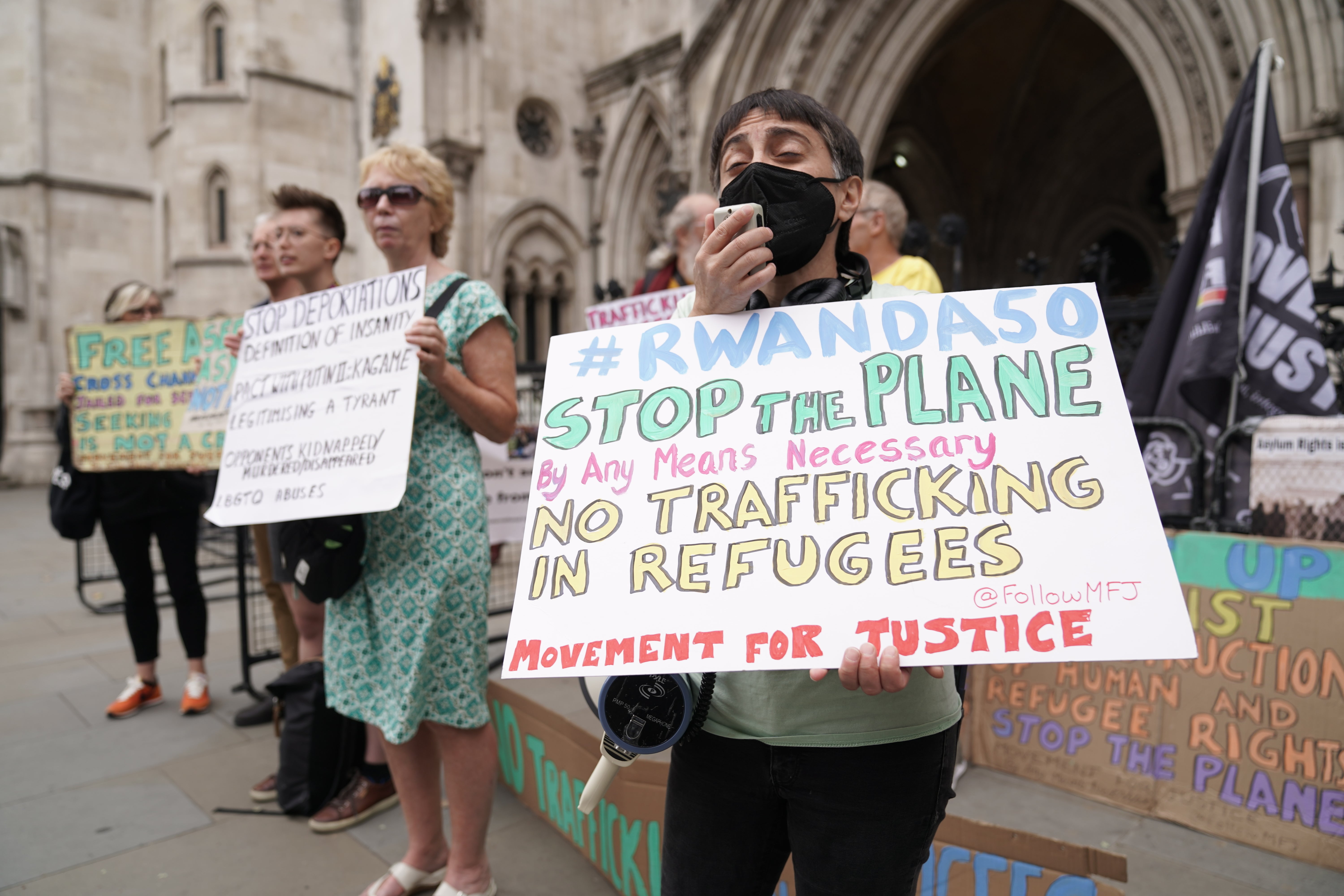 Protesters outside the High Court in London for the ruling on Rwanda deportation flights. Charities and campaigners supporting migrants are appealing against a High Court ruling on Friday which paved the way for the first deportation flight to take place on Tuesday. Picture date: Monday June 13, 2022.