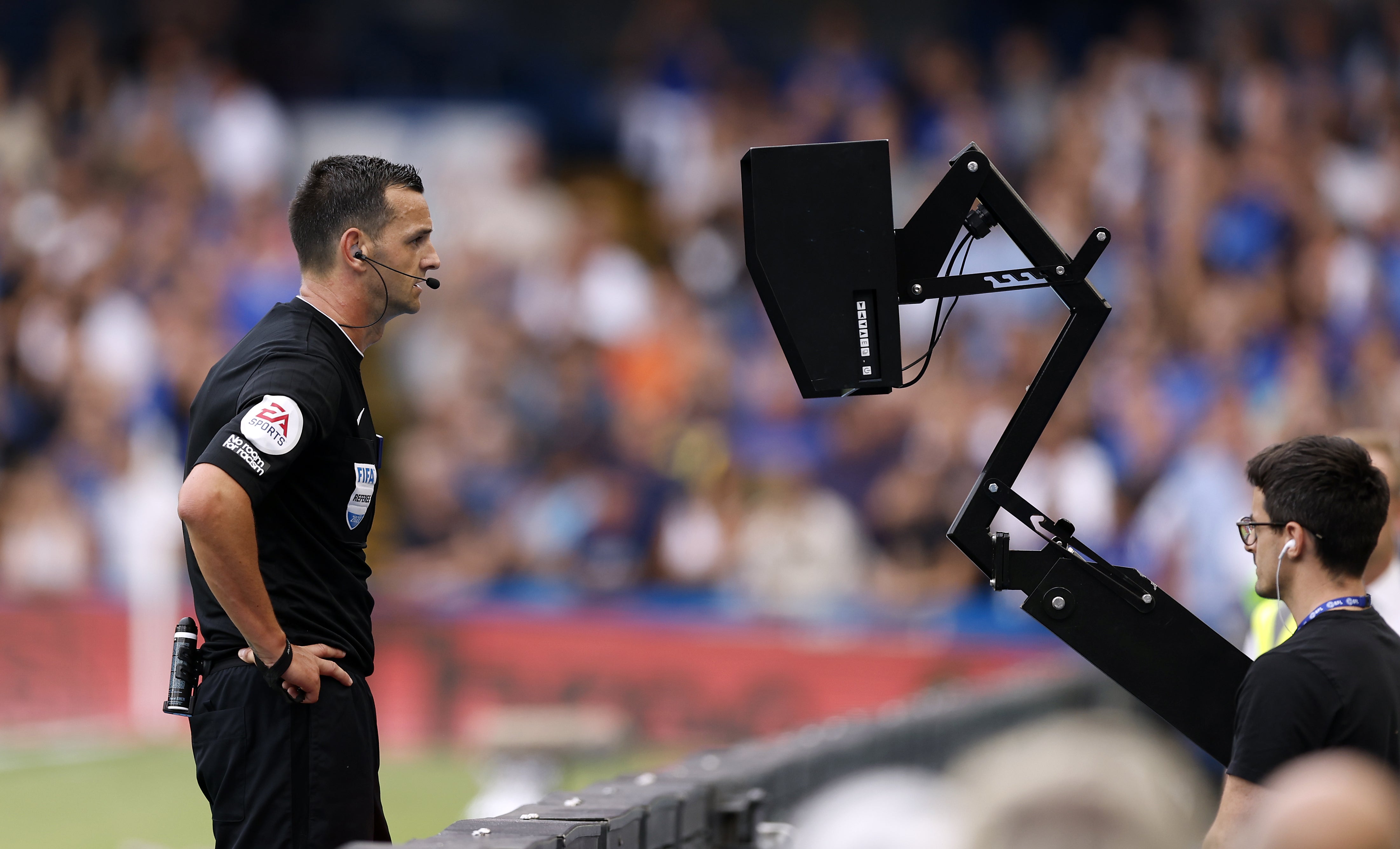 Referee Andrew Madley consults the pitch side monitor before disallowing Cornet’s equaliser (Steven Paston/PA)