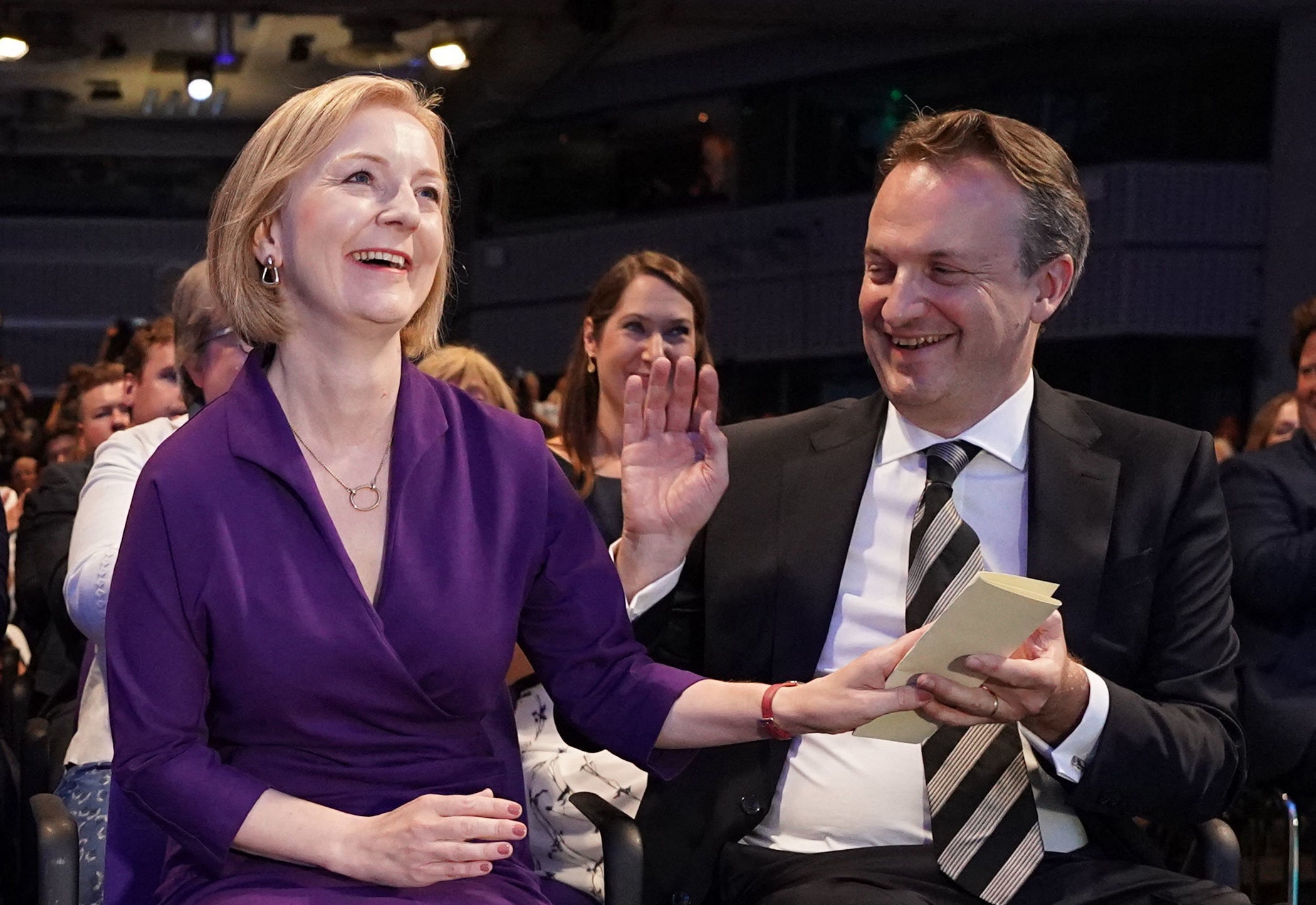 Prime Minister-elect Liz Truss (L) reacts next to her husband Hugh O'Leary as she hears the announcement of the winner of the Conservative Party leadership contest