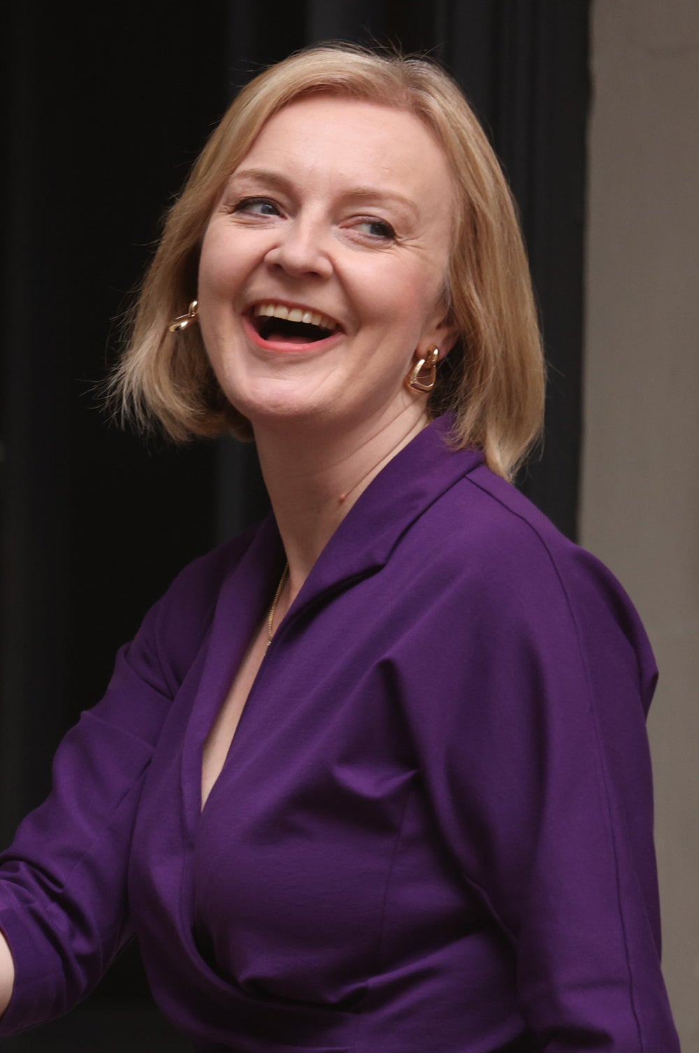 Liz Truss beams shortly after becoming Britain’s new PM