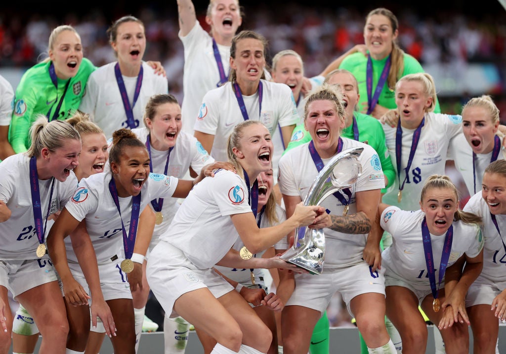 Leah Williamson and Millie Bright lift the Euro 2022 trophy after England’s victory over Germany on 31 July