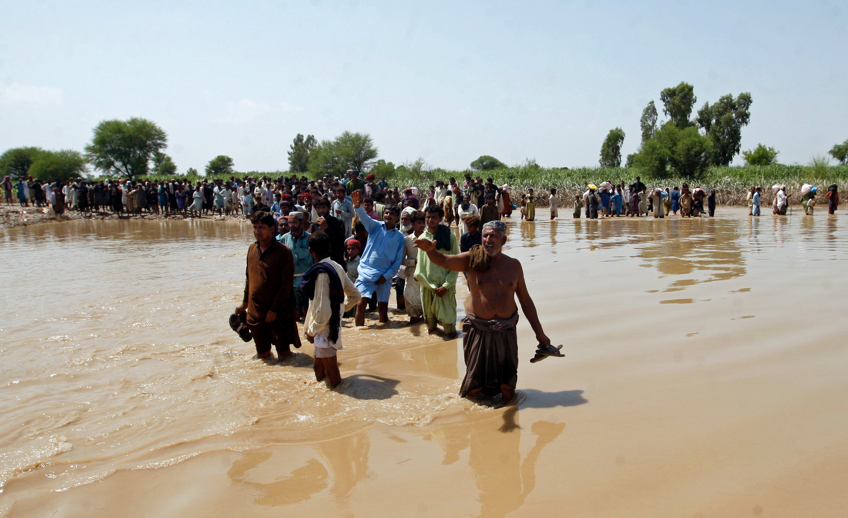 Victims line up to receive relief aid organised by the Edhi Foundation