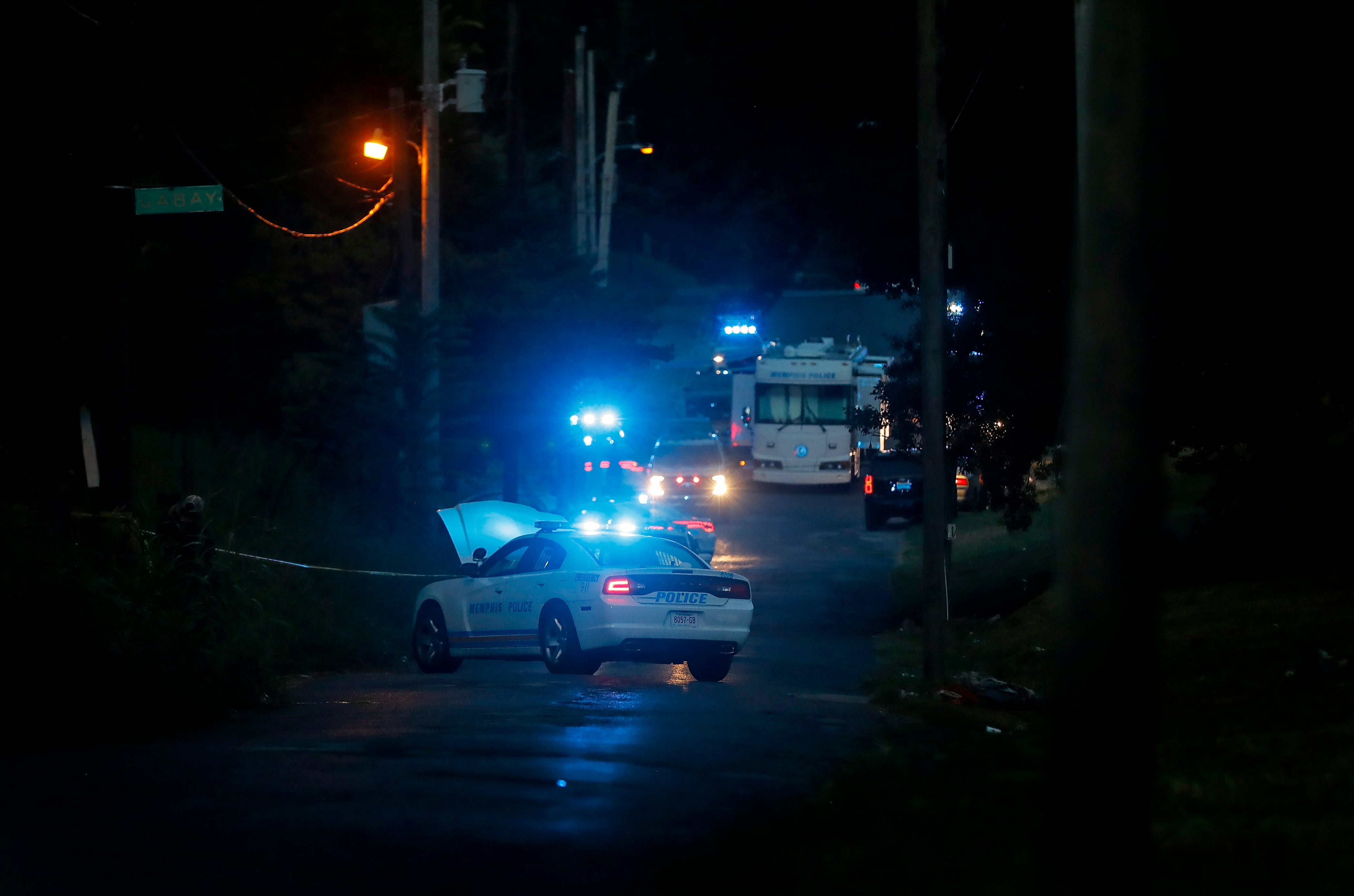 Law enforcement search the area where her body was found on Monday afternoon