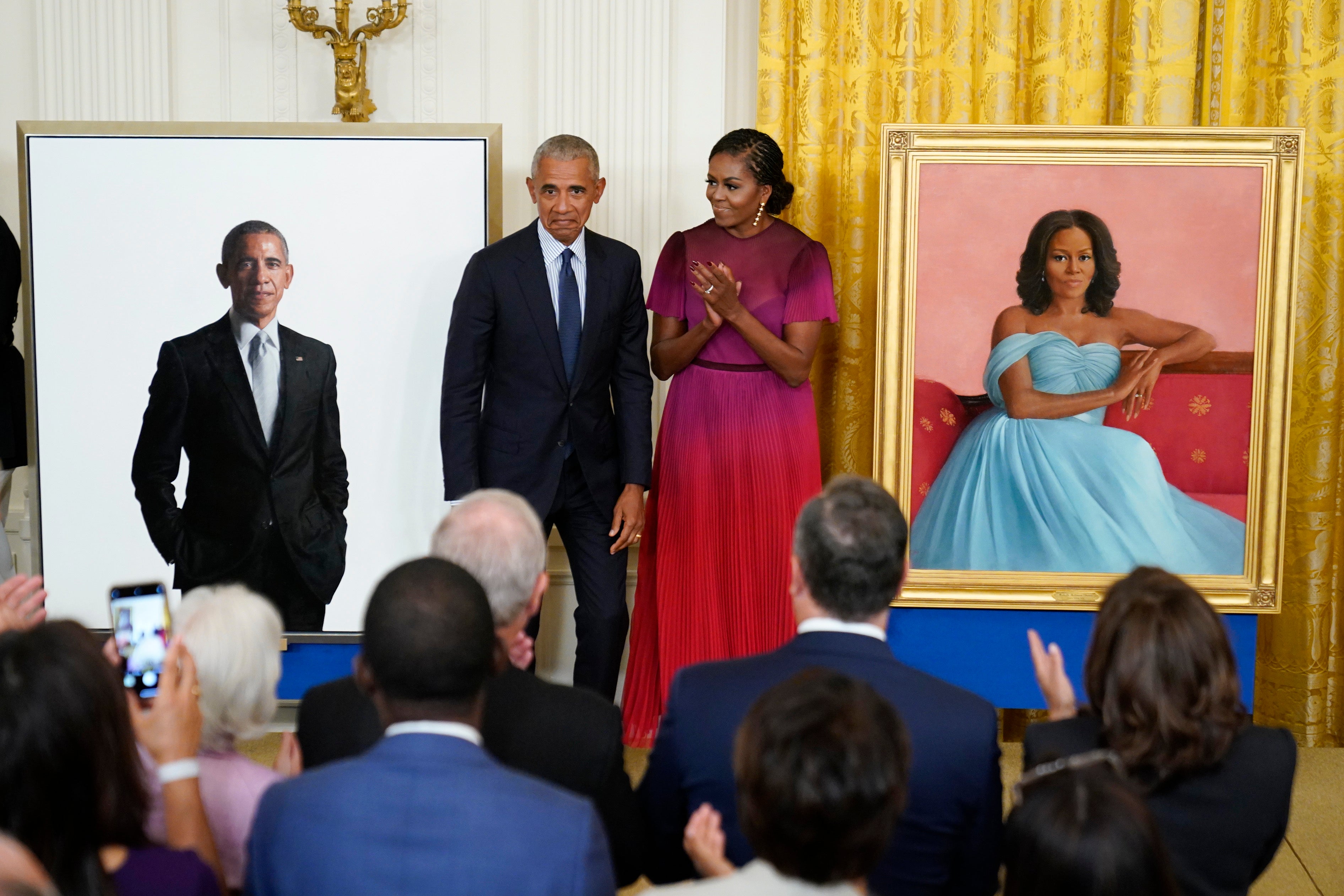 Former President Barack Obama and former first lady Michelle Obama react after unveiling their official White House portraits