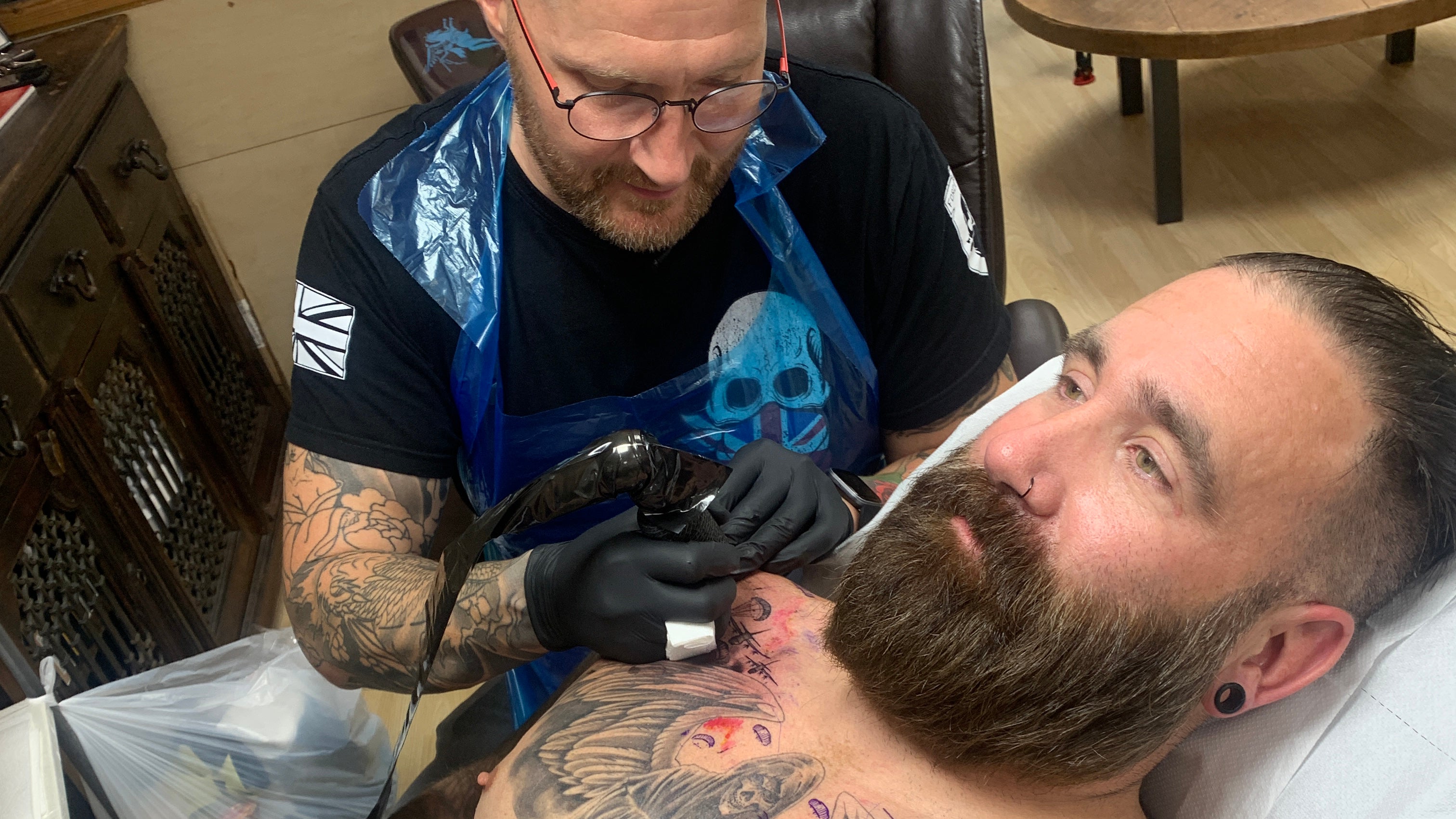 Tattoo artist Aaron Baillie working on veteran Scottie Lovegrove (Help for Heroes/PA)