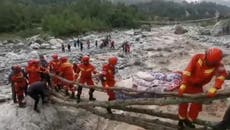 China: Firefighters carry injured villagers over raging river after deadly earthquake