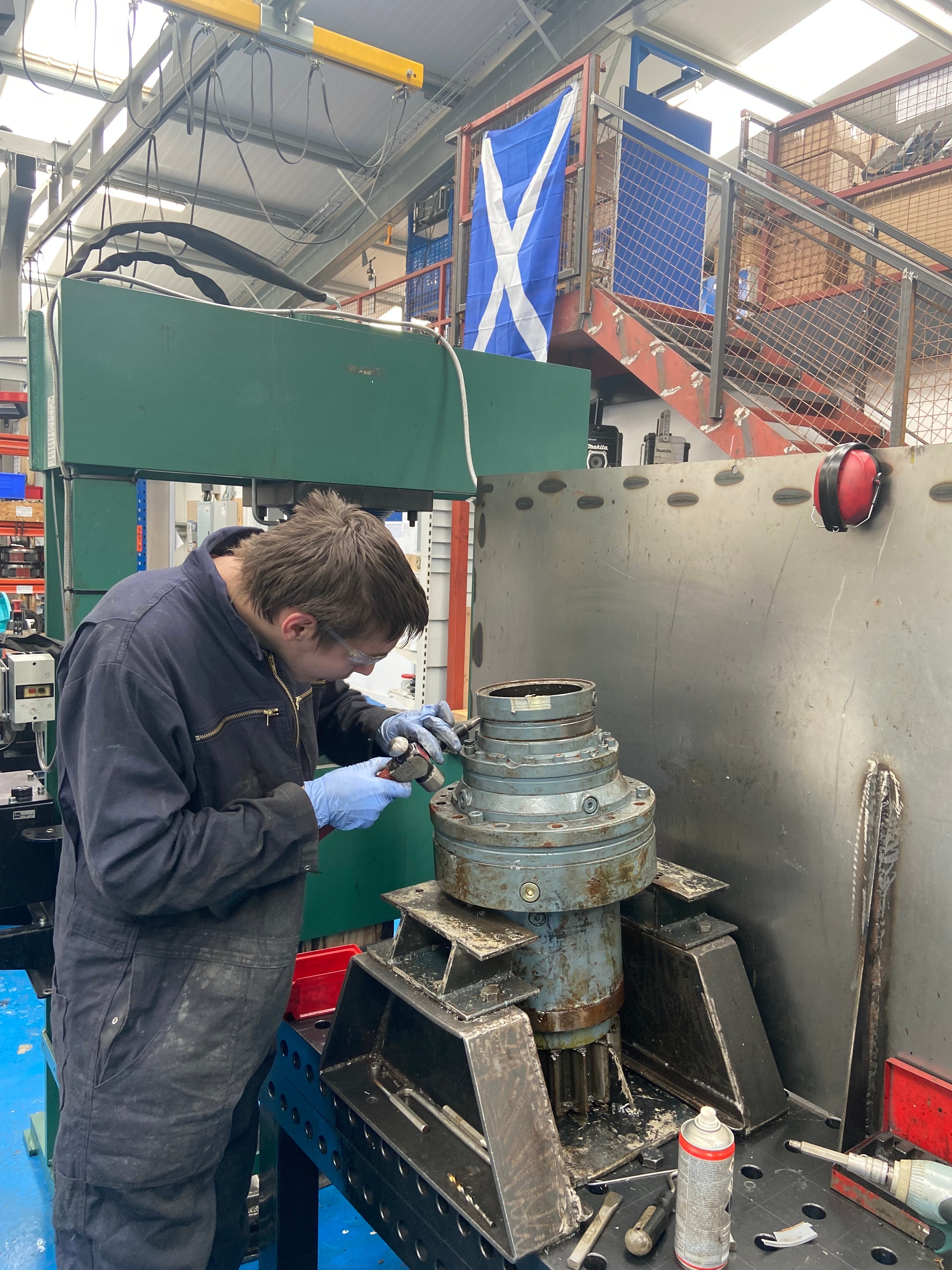 An employee at Renewable Parts works on a yaw gearbox