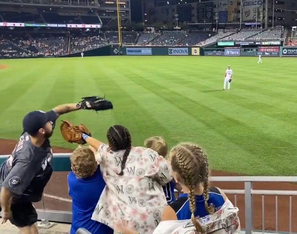 An adult at a Nationals game earlier this month caught a ball with a glove as children excitedly clamoured to get it