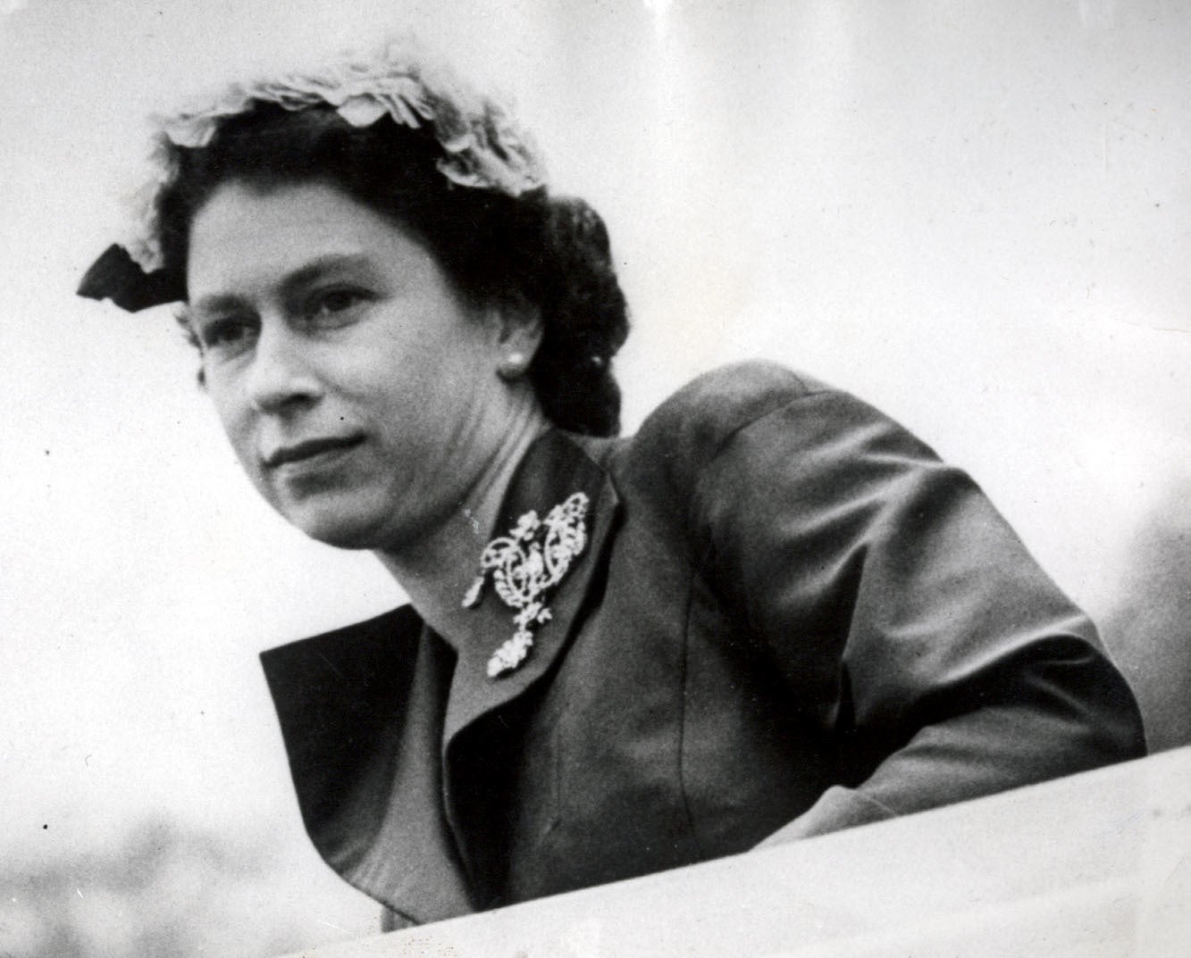 The Queen leans across the windshield of her Land Rover in 1956 (PA)