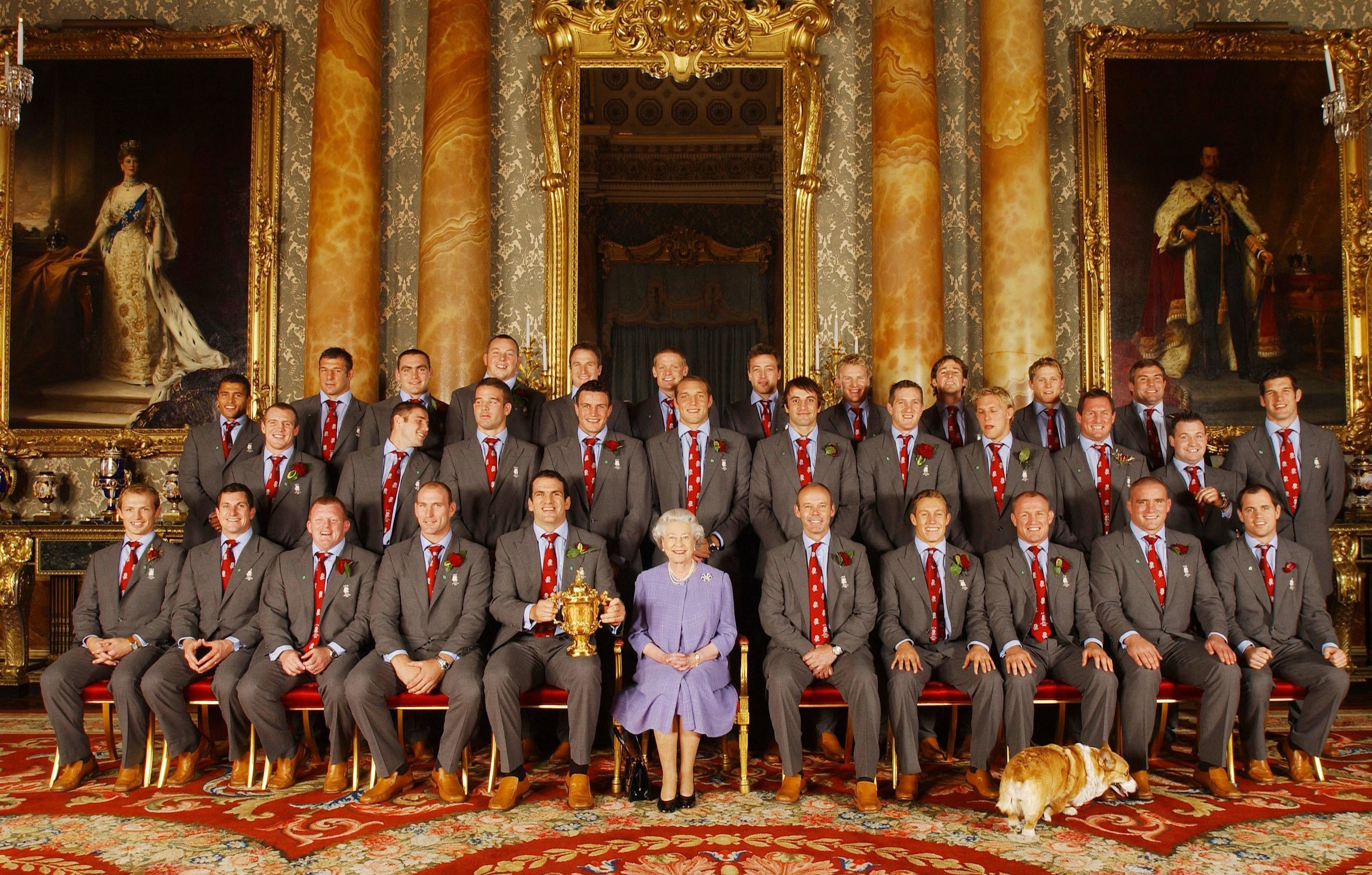 Queen Elizabeth II posed, with the England rugby squad at a reception at Buckingham Palace in London to celebrate winning the Rugby World Cup (Kirsty Wigglesworth/PA)