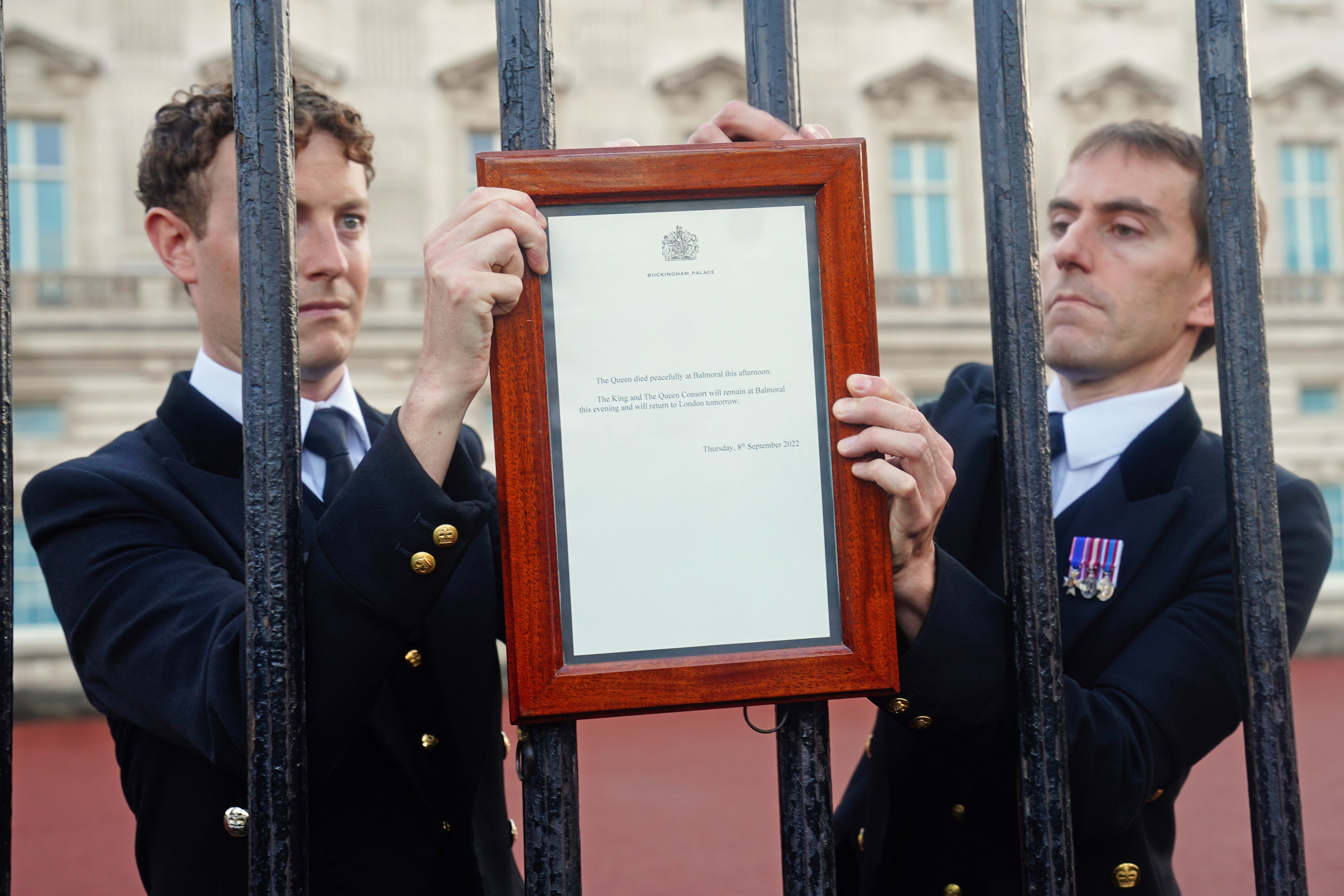 The two royal aides appeared nervous as they fixed the notice announcing the death of the Queen to the Palace gates