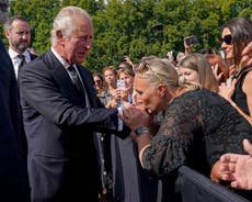 King Charles kissed by well-wishers as he meets crowds lining street outside Buckingham Palace