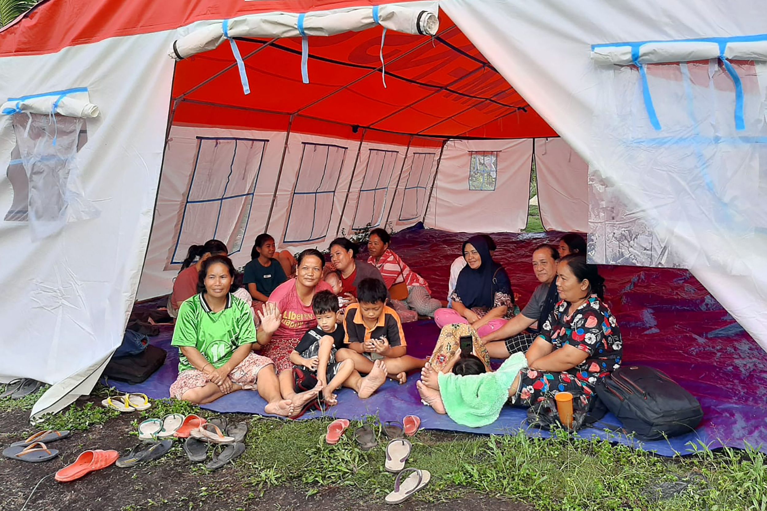 People gather in a temporary shelter following an earthquake off Indonesia’s Mentawai Islands, at Muara Sikabaluan village in Siberut Utara, West Sumatra province on 11 September 2022