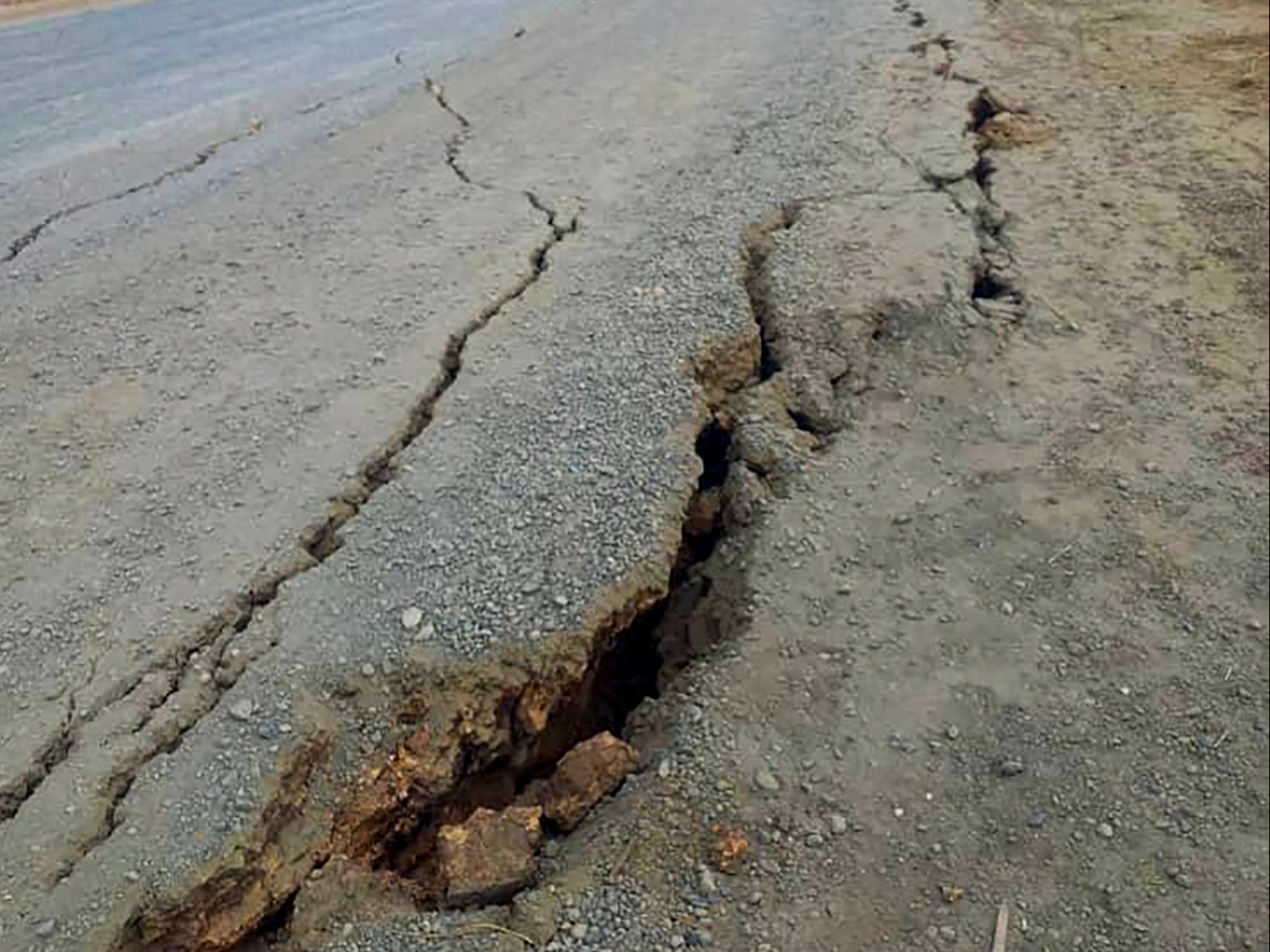 Debris lies strewn across a highway following a landslide near the town of Kainantu, following a 7.6-magnitude earthquake