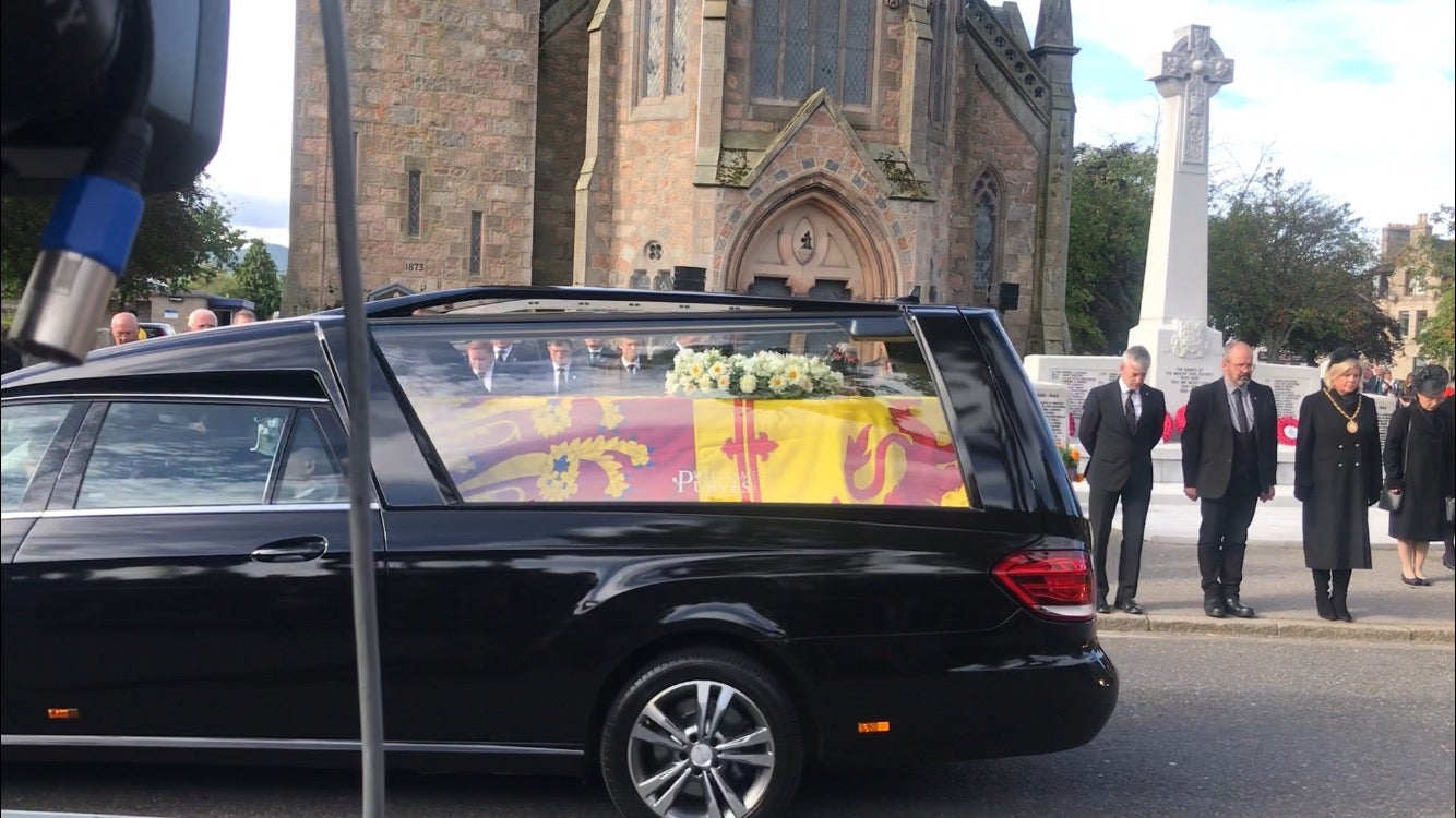 The Queen’s coffin passes through Ballater as mourners look on