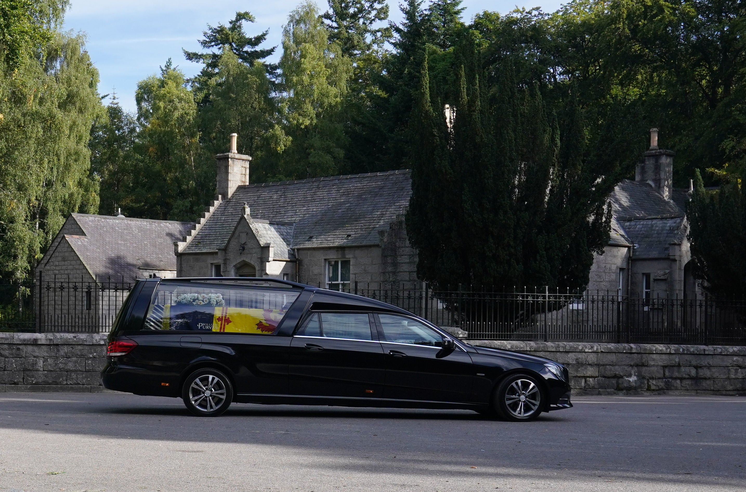 The coffin passed through the village of Ballater shortly after leaving Balmoral