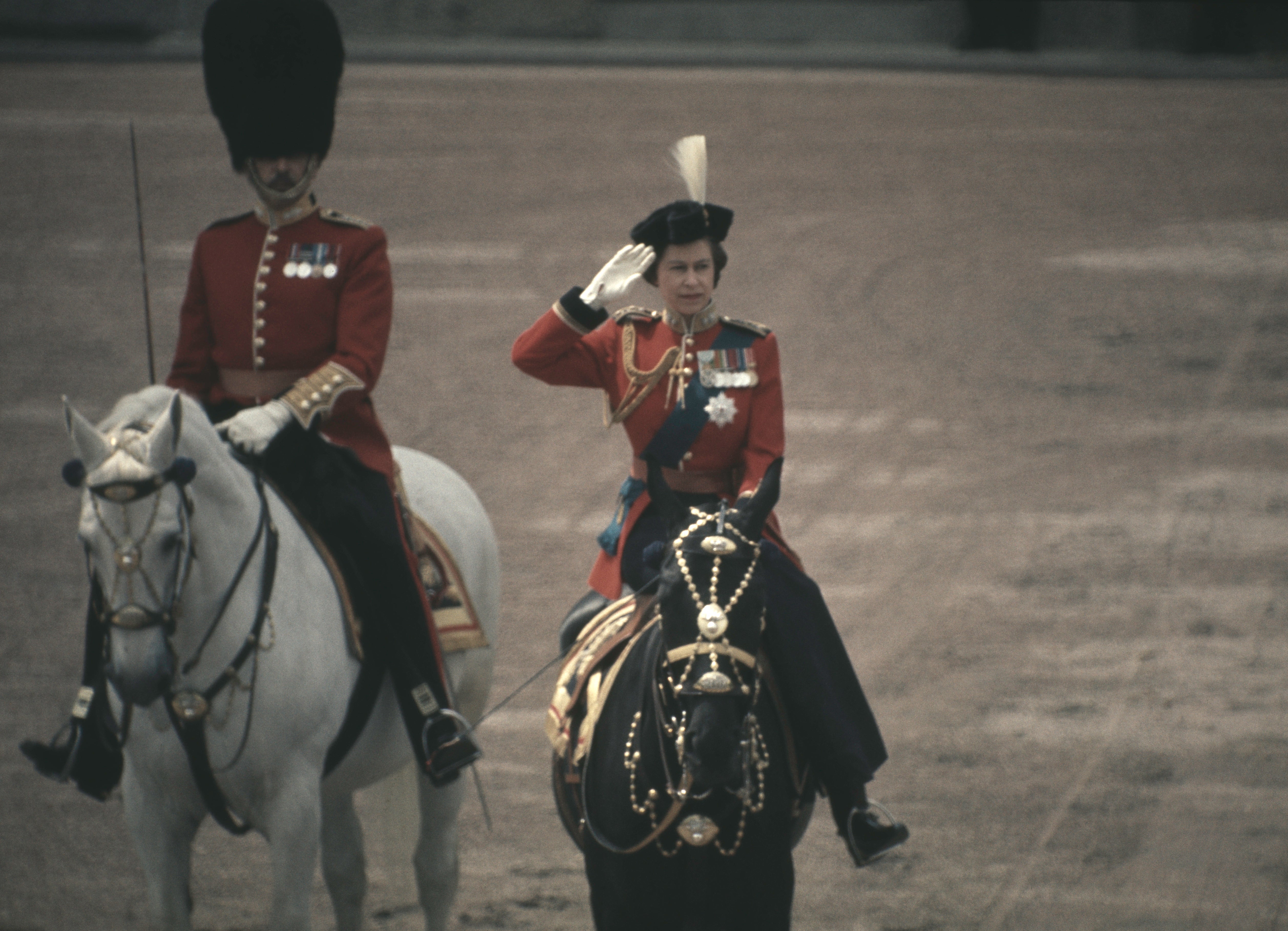 The Queen riding side-saddle as she returns to Buckingham Palace, London, after attending the Trooping the Colour ceremony on Horse Guards Parade, 1971. The parade is held in honour of the Queen’s official birthday