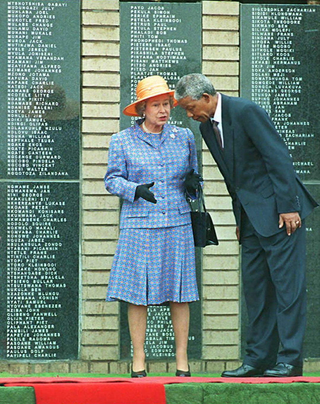 The Queen with Nelson Mandela as she unveils a memorial to 600 black soldiers who died when the SS-Mendi sank in the English Channel during World War I, in Soweto, near Johannesburg, 1995