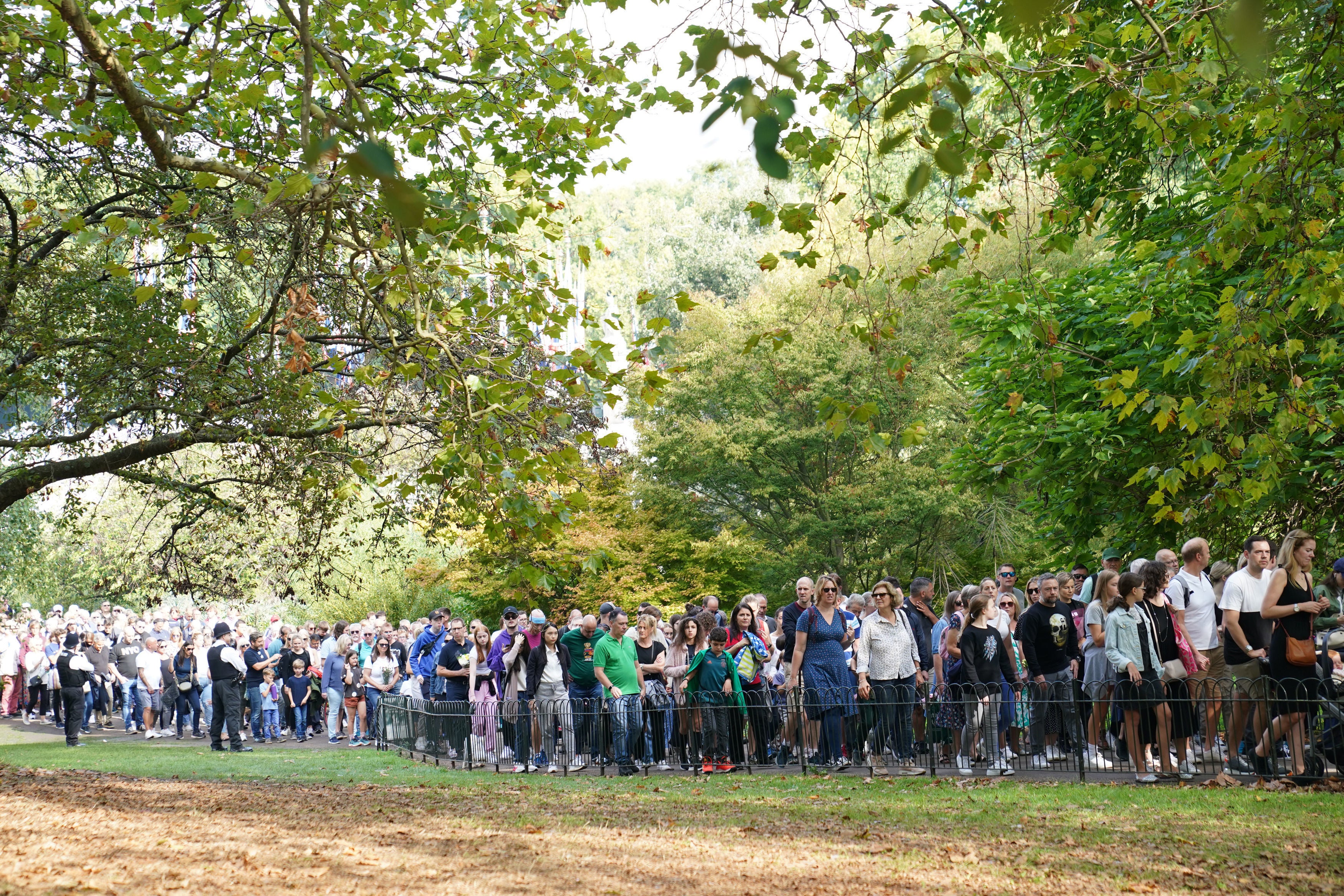 Large crowds wait in long queues to get to Buckingham Palace