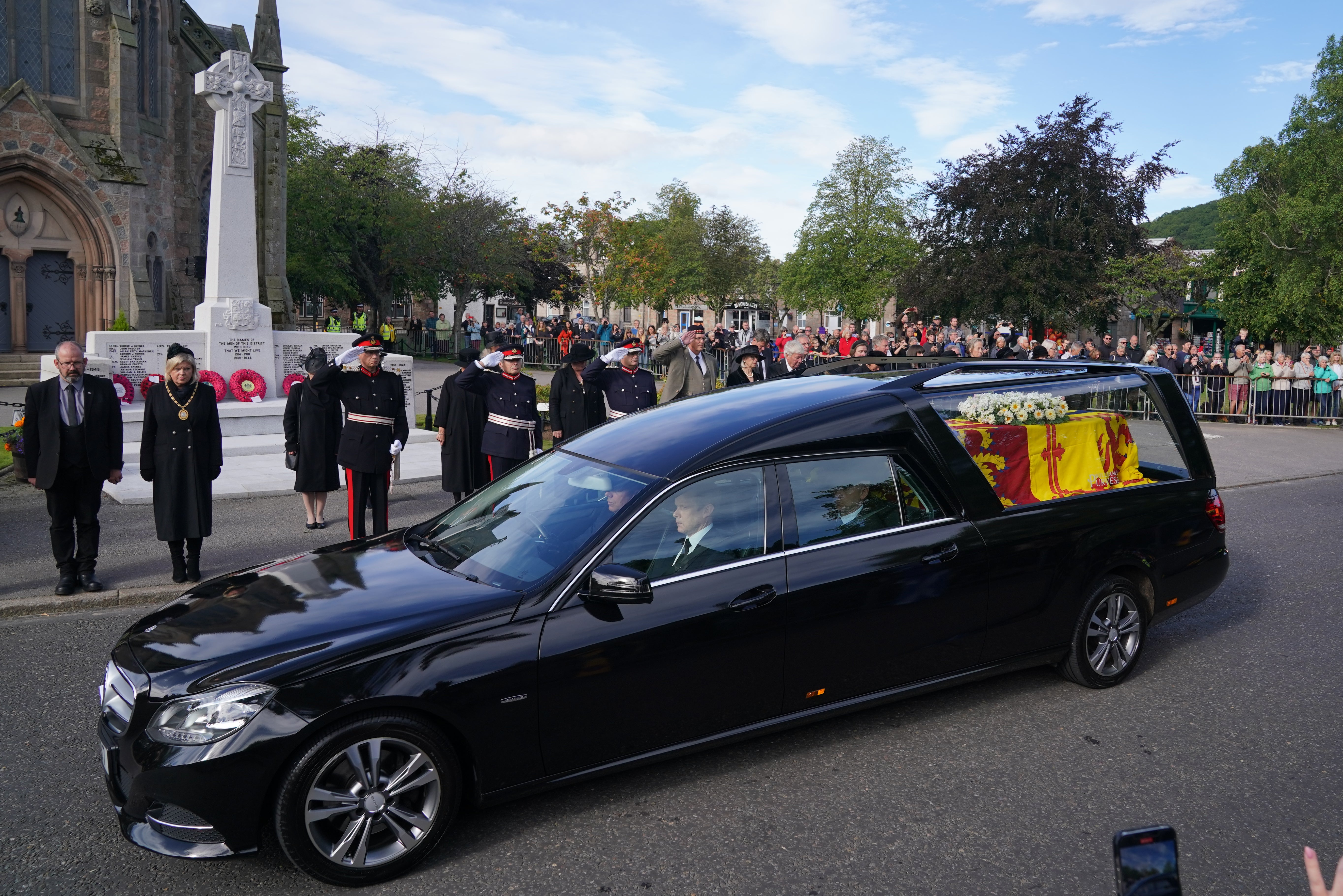 Members of the military salute the hearse carrying the coffin of Queen Elizabeth II (PA)