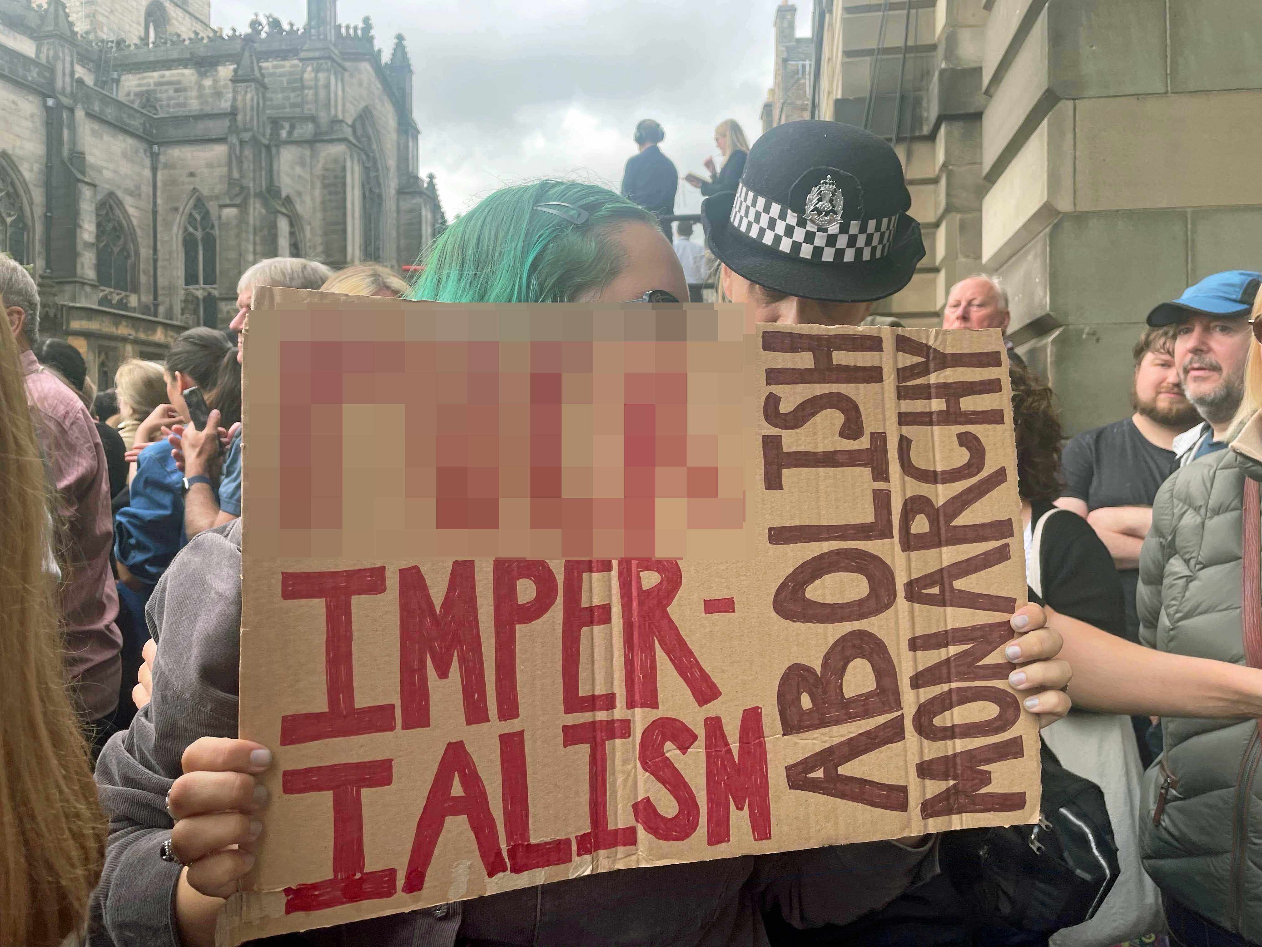 A protester before the Accession Proclamation Ceremony at Mercat Cross, Edinburgh, publicly proclaiming King Charles III as the new monarch