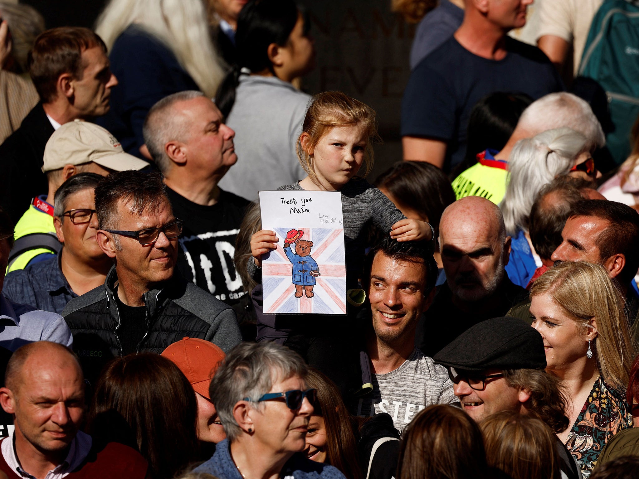 Mourners gather to watch the procession of Queen Elizabeth II’s coffin on Monday