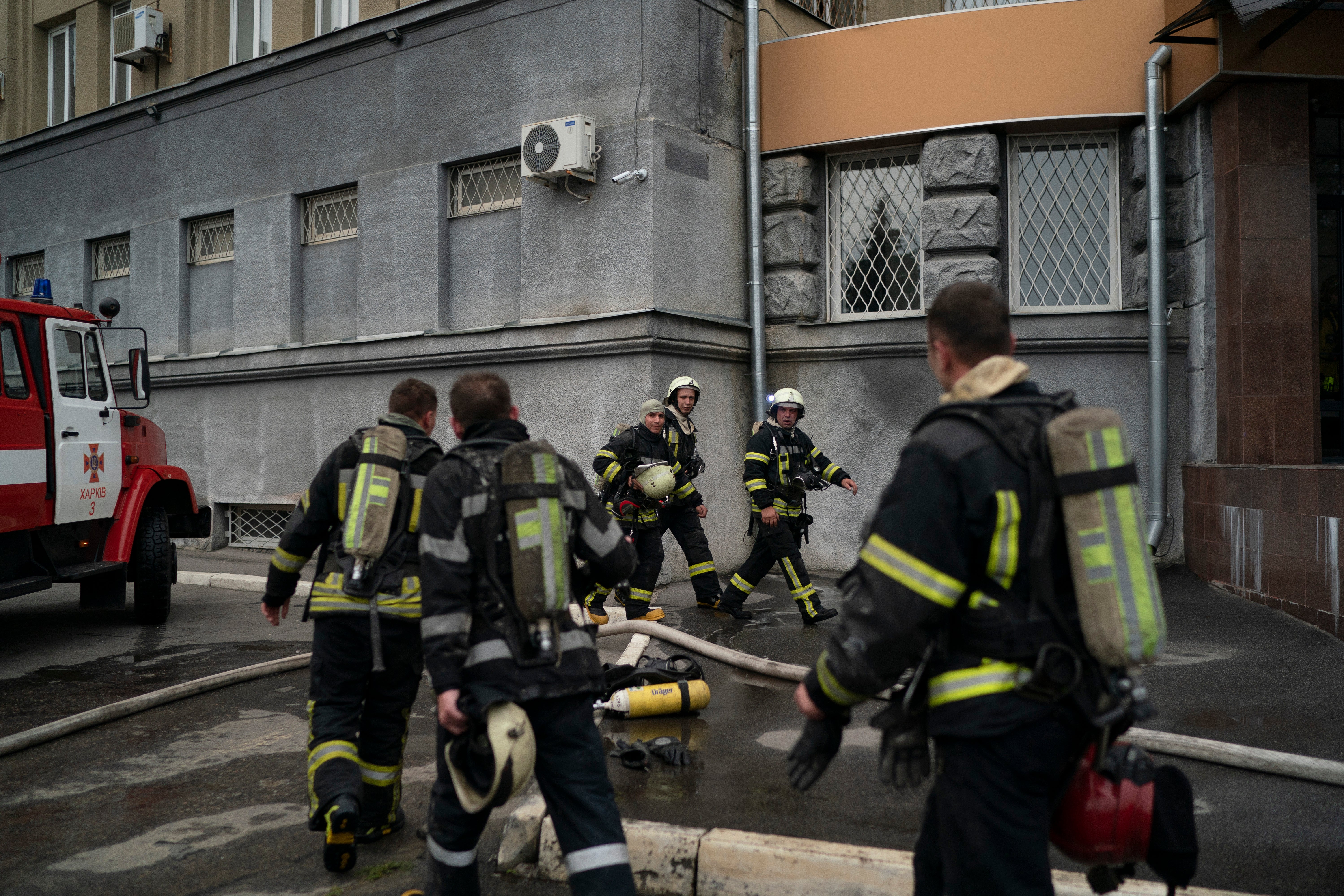 Firefighters work to put out a fire in a Kharkiv police building caused by a Russian attack