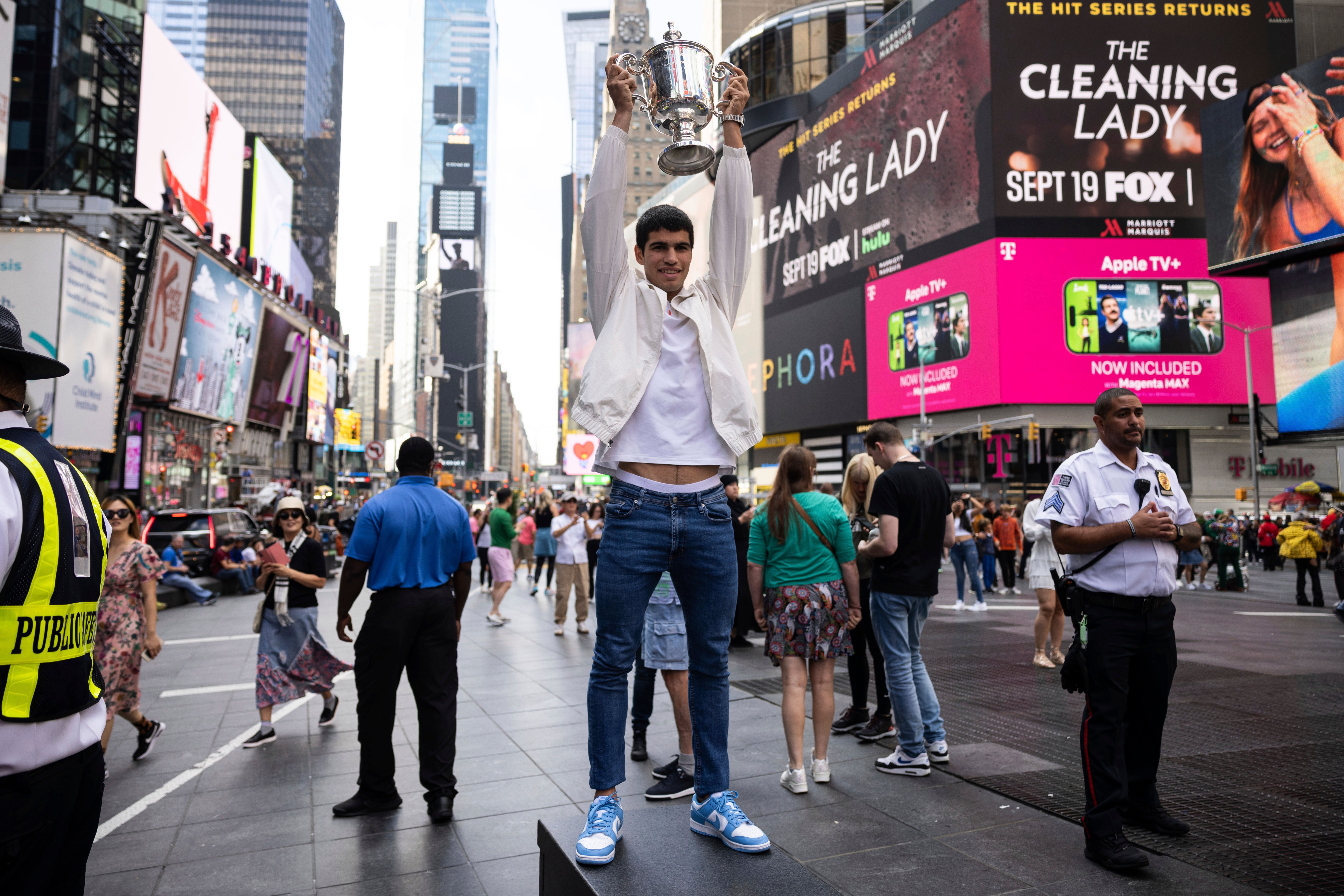 Carlos Alcaraz held up the US Open trophy in Times Square (Yuki Iwamura/AP)