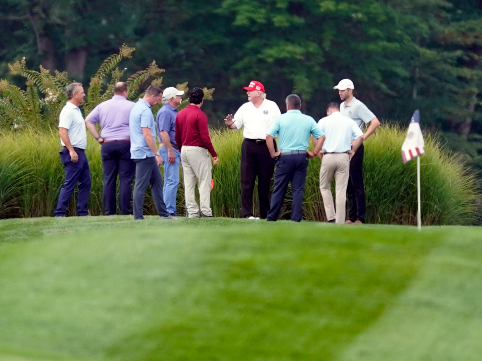 Donald Trump talks to aides and advisers at Trump National Golf Club in Sterling, Virginia