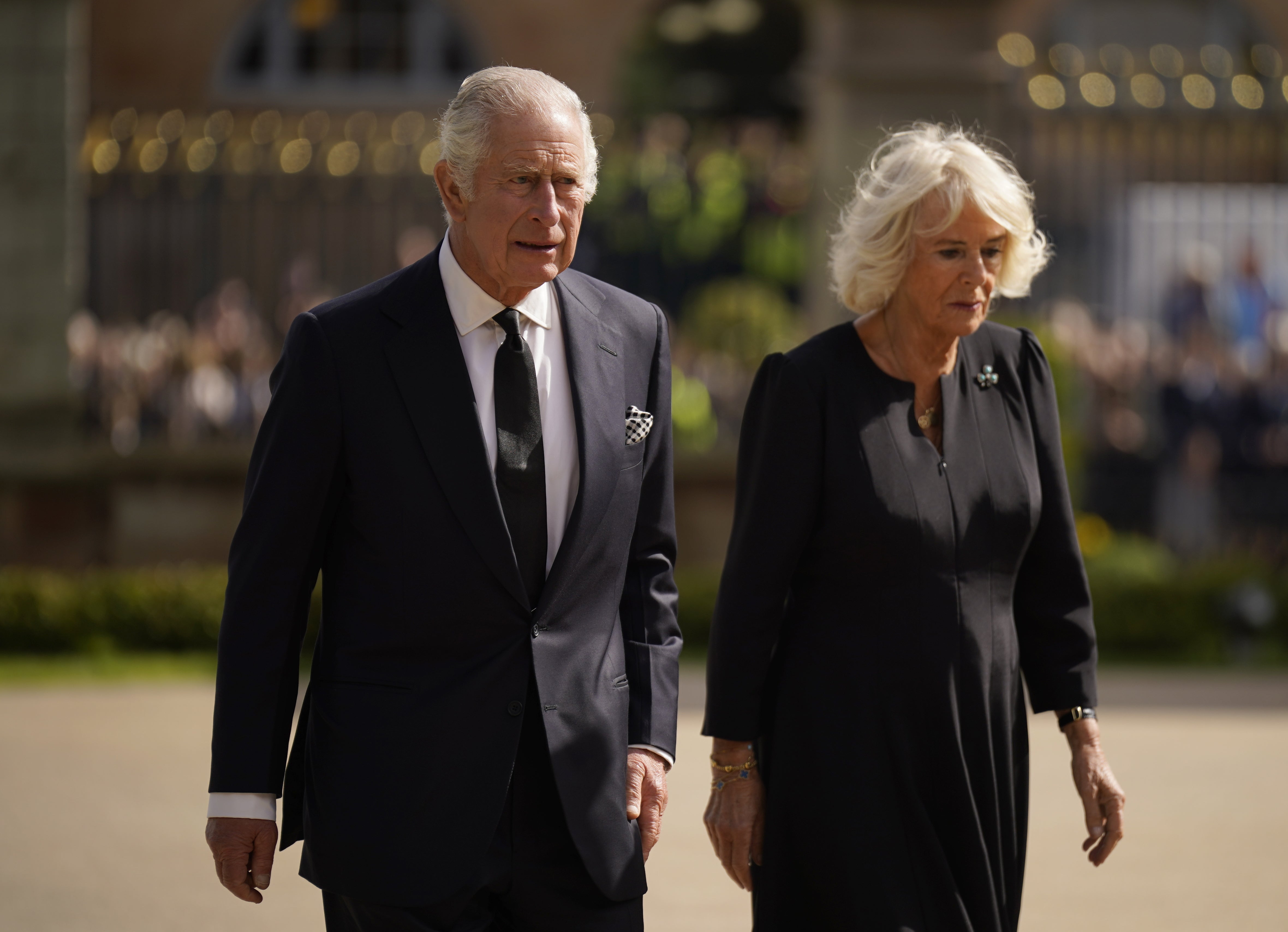 King Charles III and the Queen Consort view floral tributes left outside Hillsborough Castle, Co Down, following the death Queen Elizabeth II on Thursday. Picture date: Tuesday September 13, 2022.