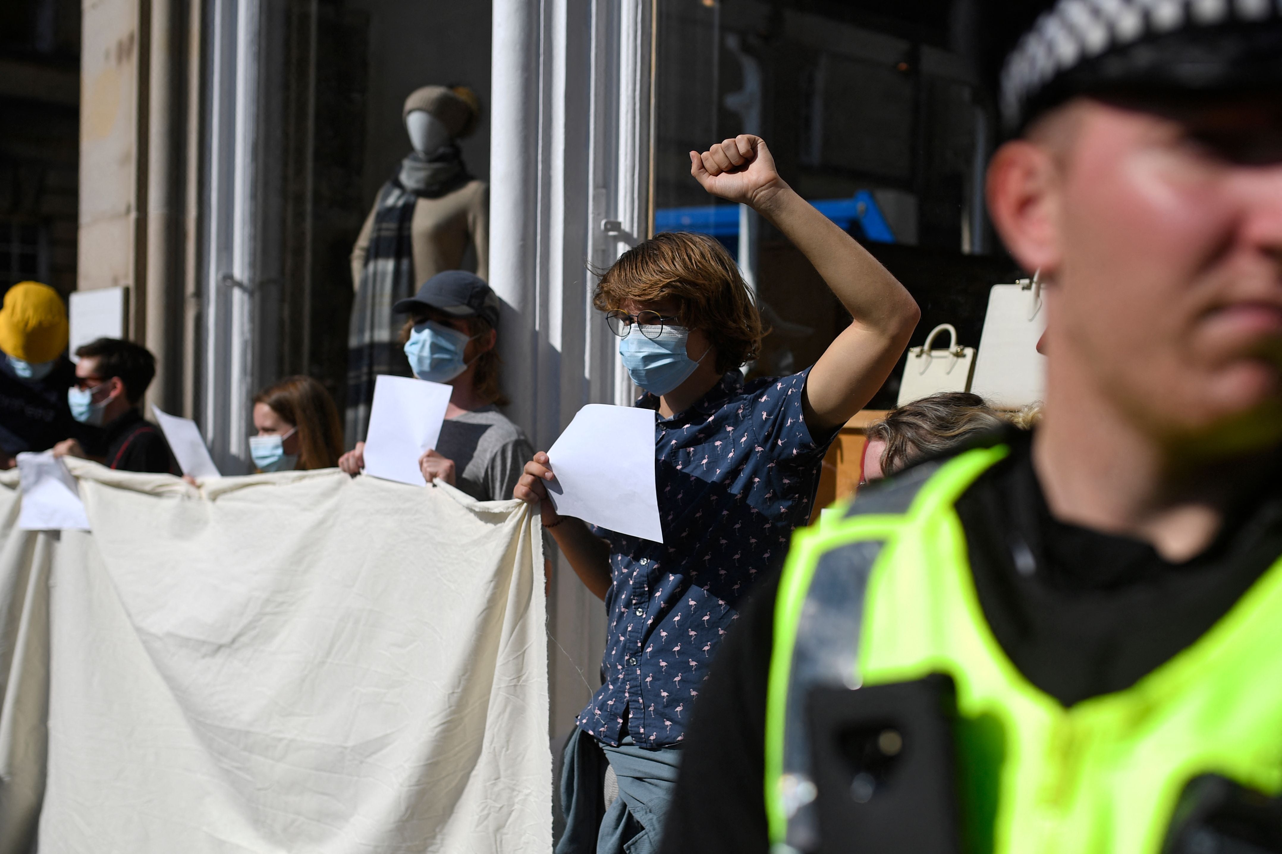 Anti-royalist protesters hold up blank placards in a demonstration against the way their protests are being policed, in Edinburgh.