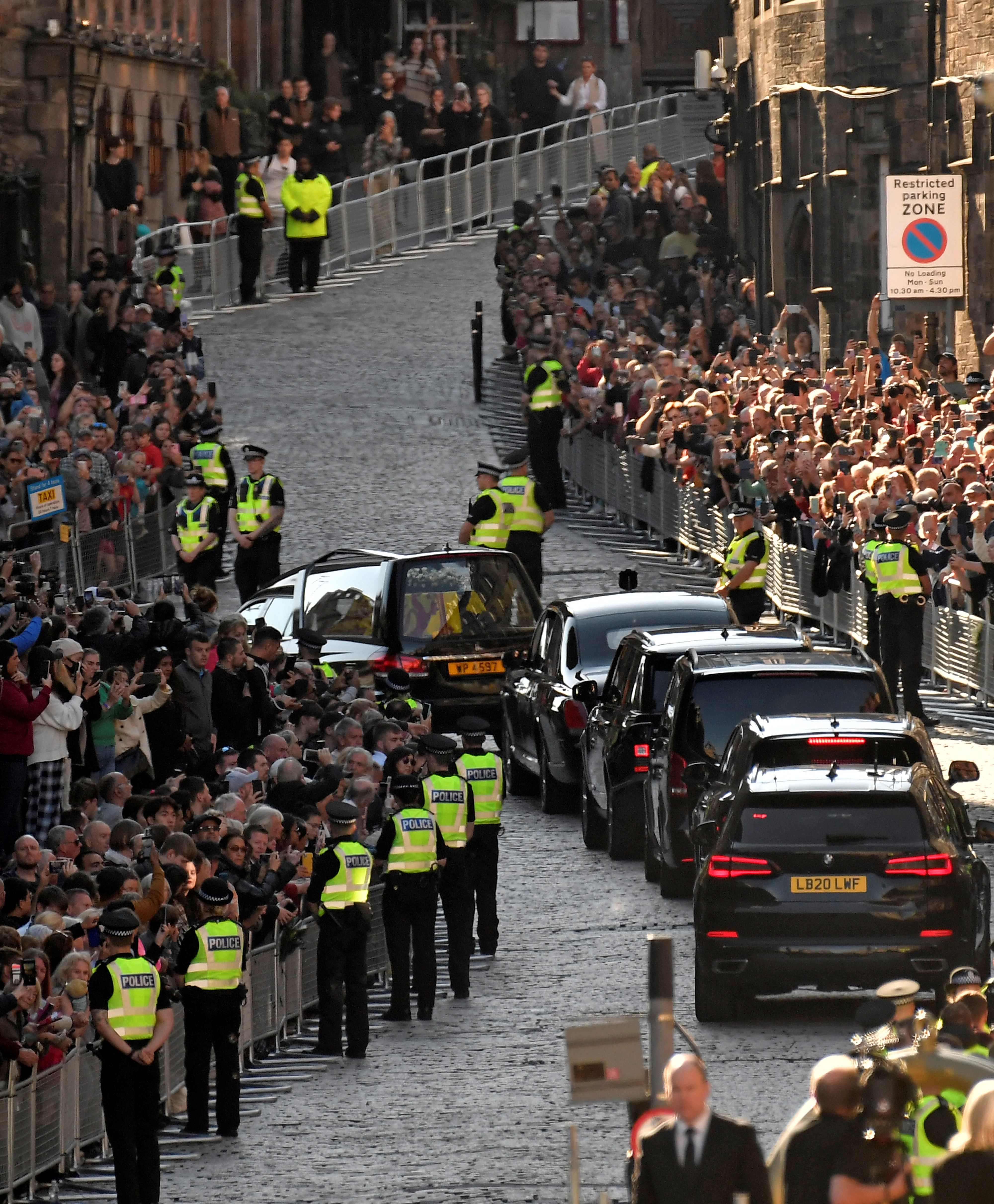 Crowds applauded as the cars were driven away