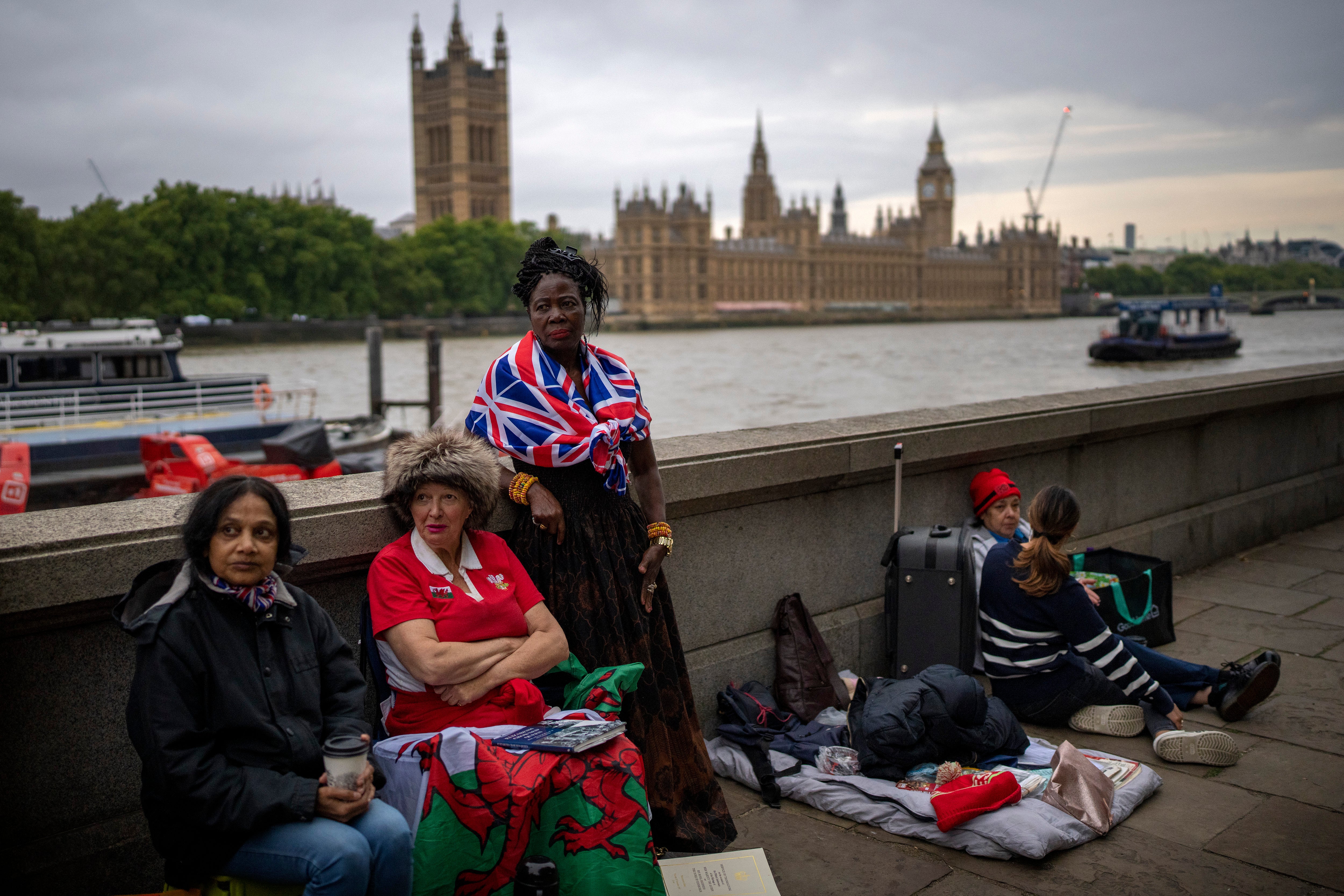 Mourners wait opposite the Palace of Westminster to be first in line to bid farewell to Queen