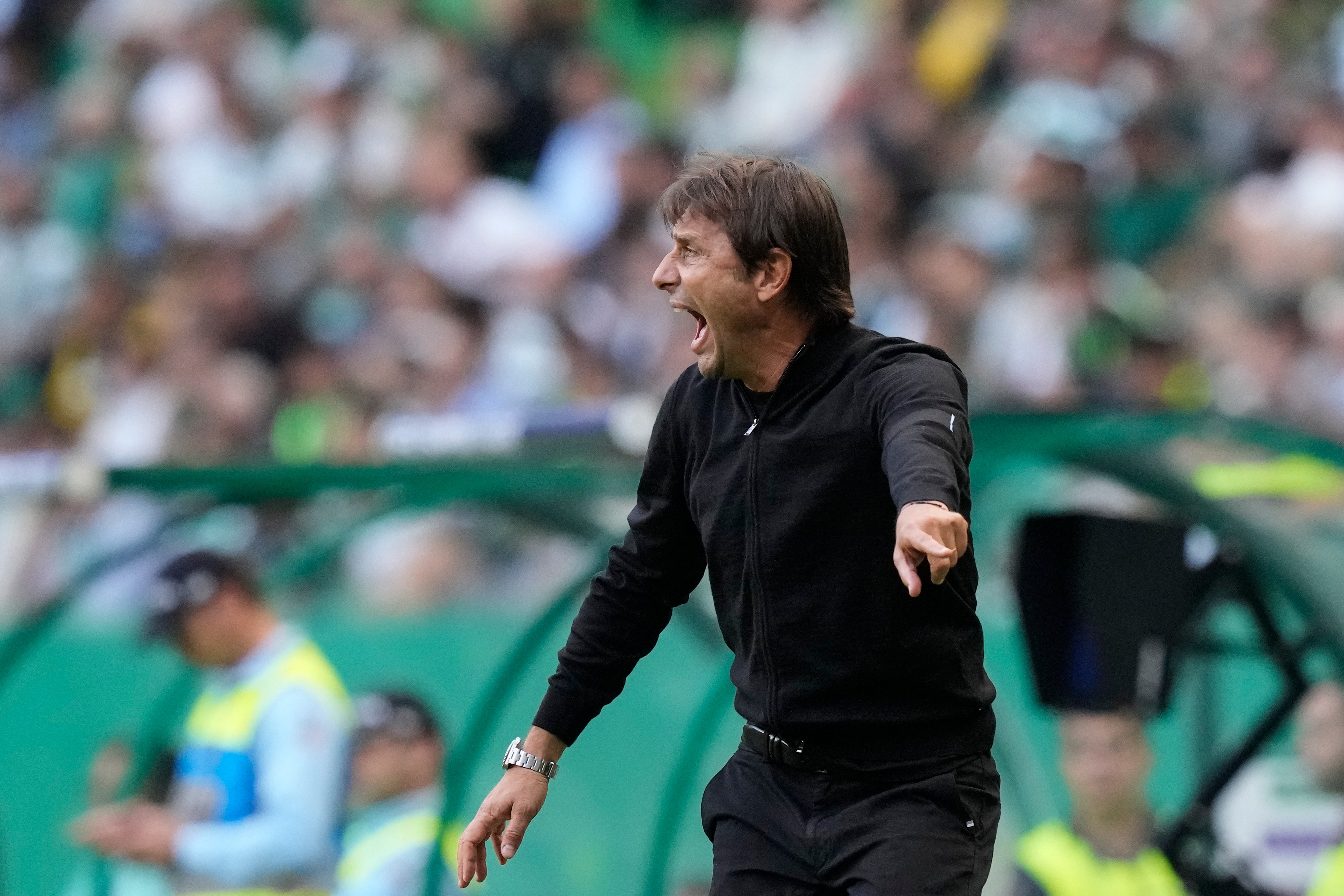 Antonio Conte saw his side suffer a late defeat in Lisbon (Armando Franca/AP)