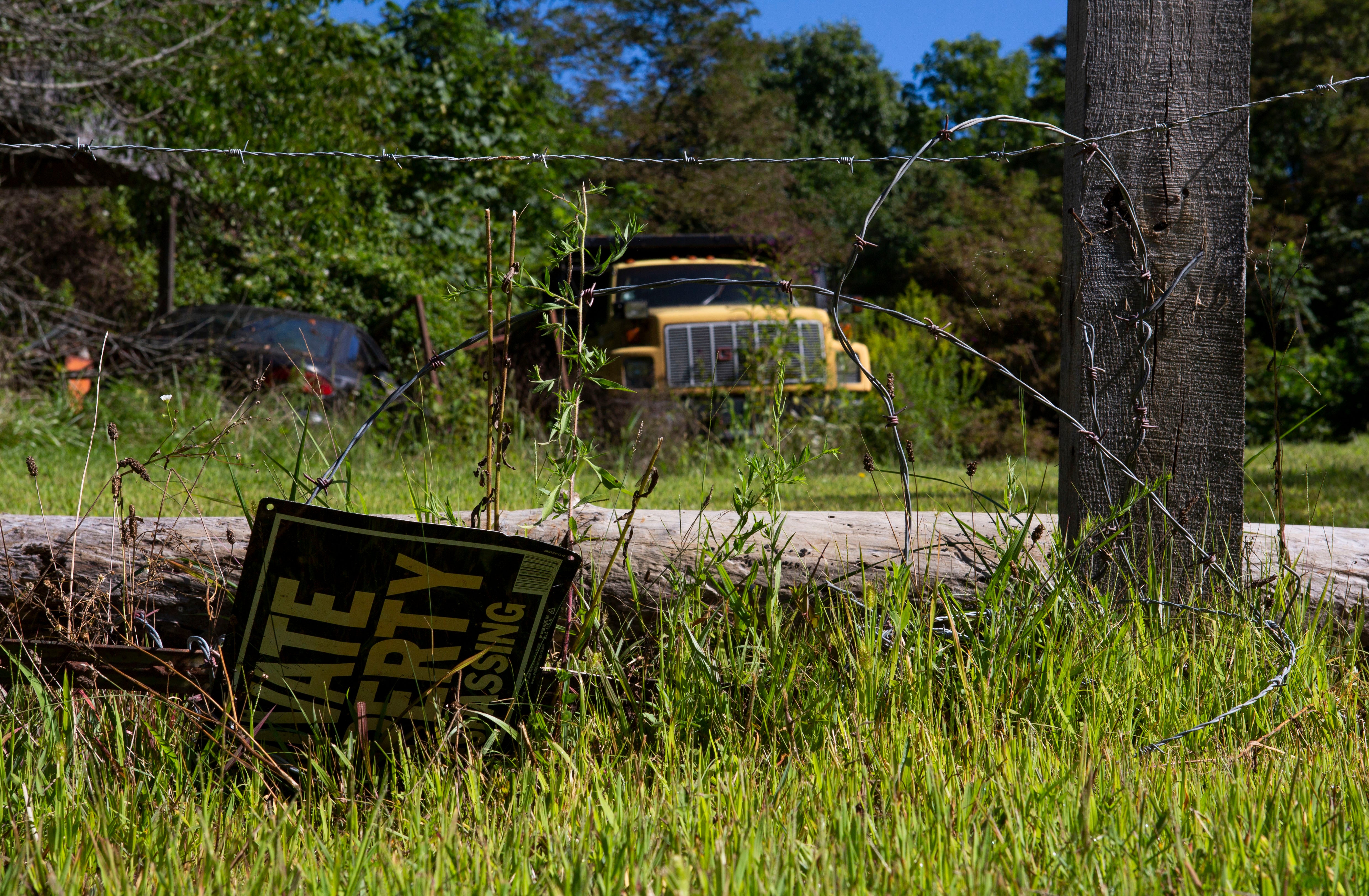 Vehicles at the site of the trailer park where Christopher Rhoden Sr and Gary Rhoden were killed in April 2016