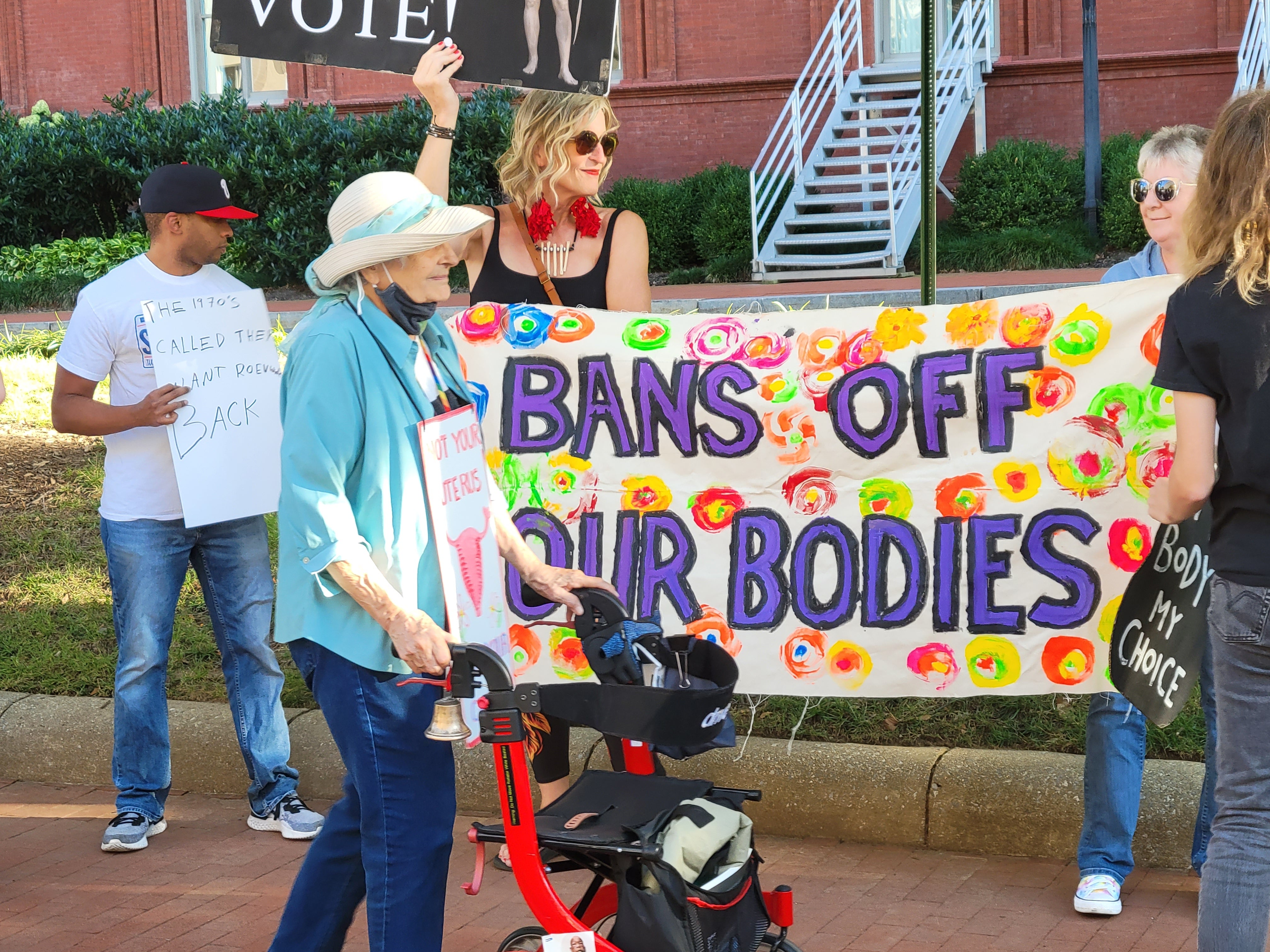 A handful of demonstrators unfurled a banner as a crowd chanted at GOP senators inside the gala