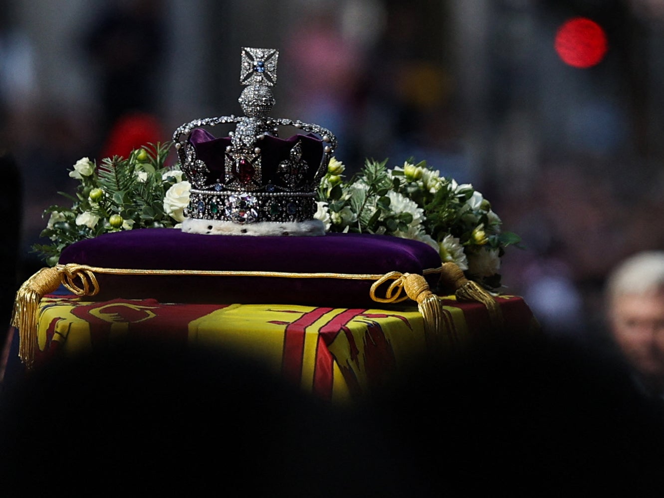 The coffin of Queen Elizabeth II, adorned with a Royal Standard and the Imperial State Crown is pulled by a Gun Carriage of The King’s Troop Royal Horse Artillery