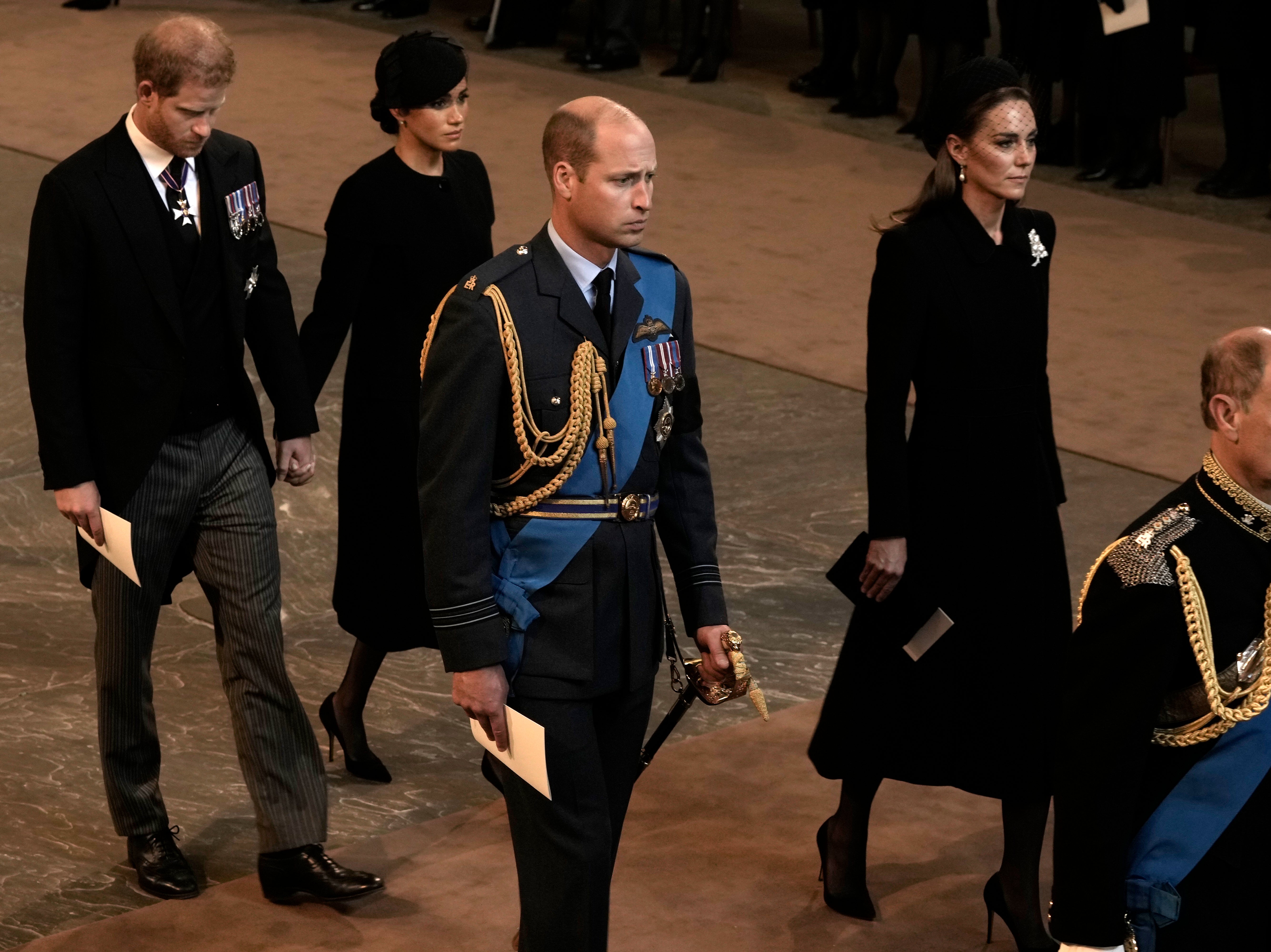 The Duke and Duchess of Sussex held hands as they left Westminster Hall after the service