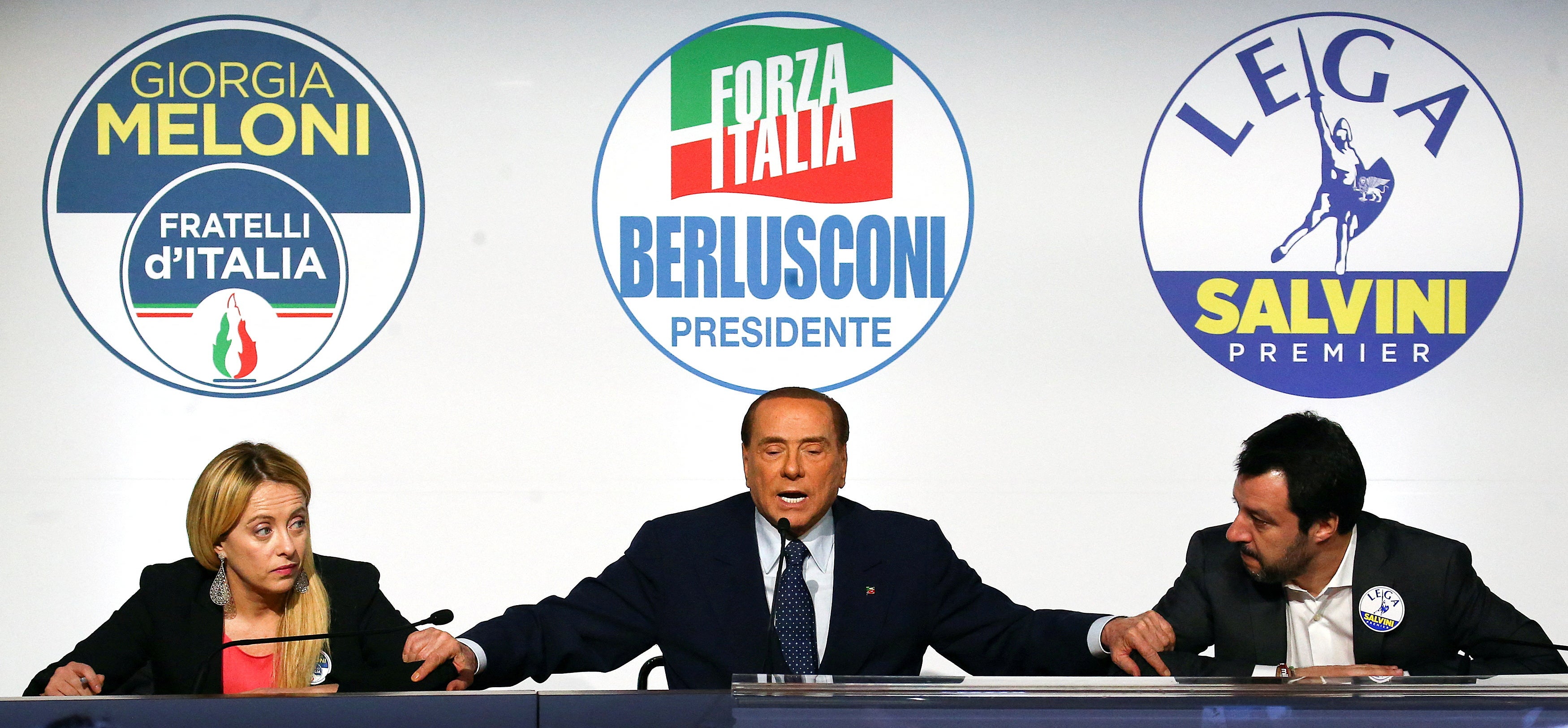 Forza Italia leader Silvio Berlusconi speaks flanked by Meloni and Matteo Salvini in 2018