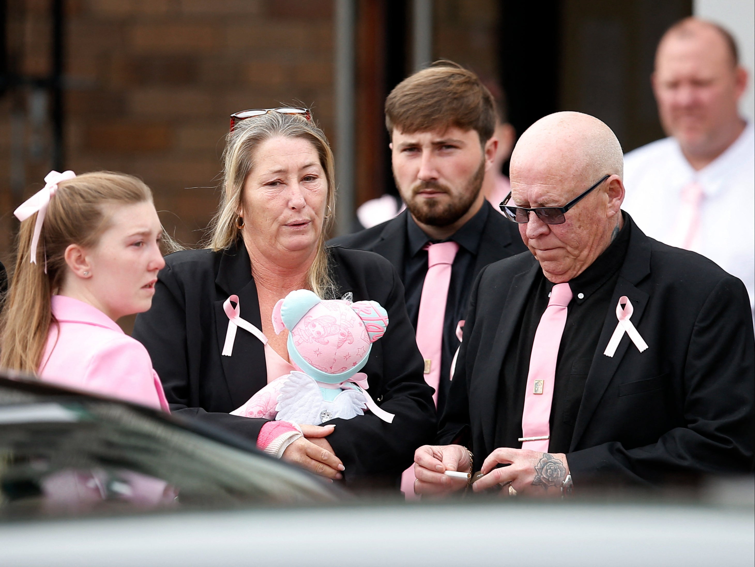 Olivia’s mother Cheryl Korbel carried a pink teddy as she arrived for the funeral at St Margaret Mary’s Church in Knotty Ash