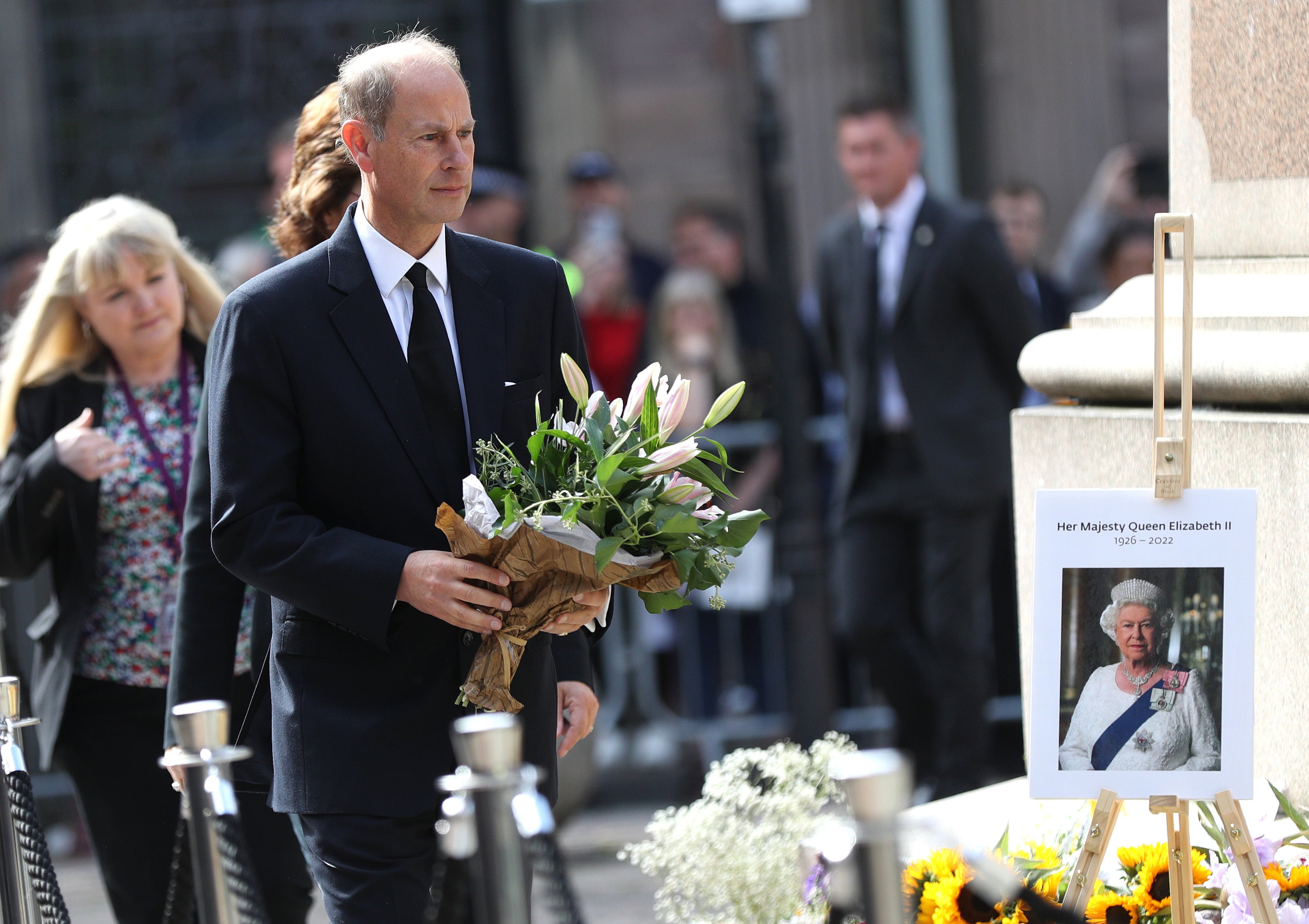 Prince Edward, Earl of Wessex, views floral tributes during a visit to Manchester on Thursday