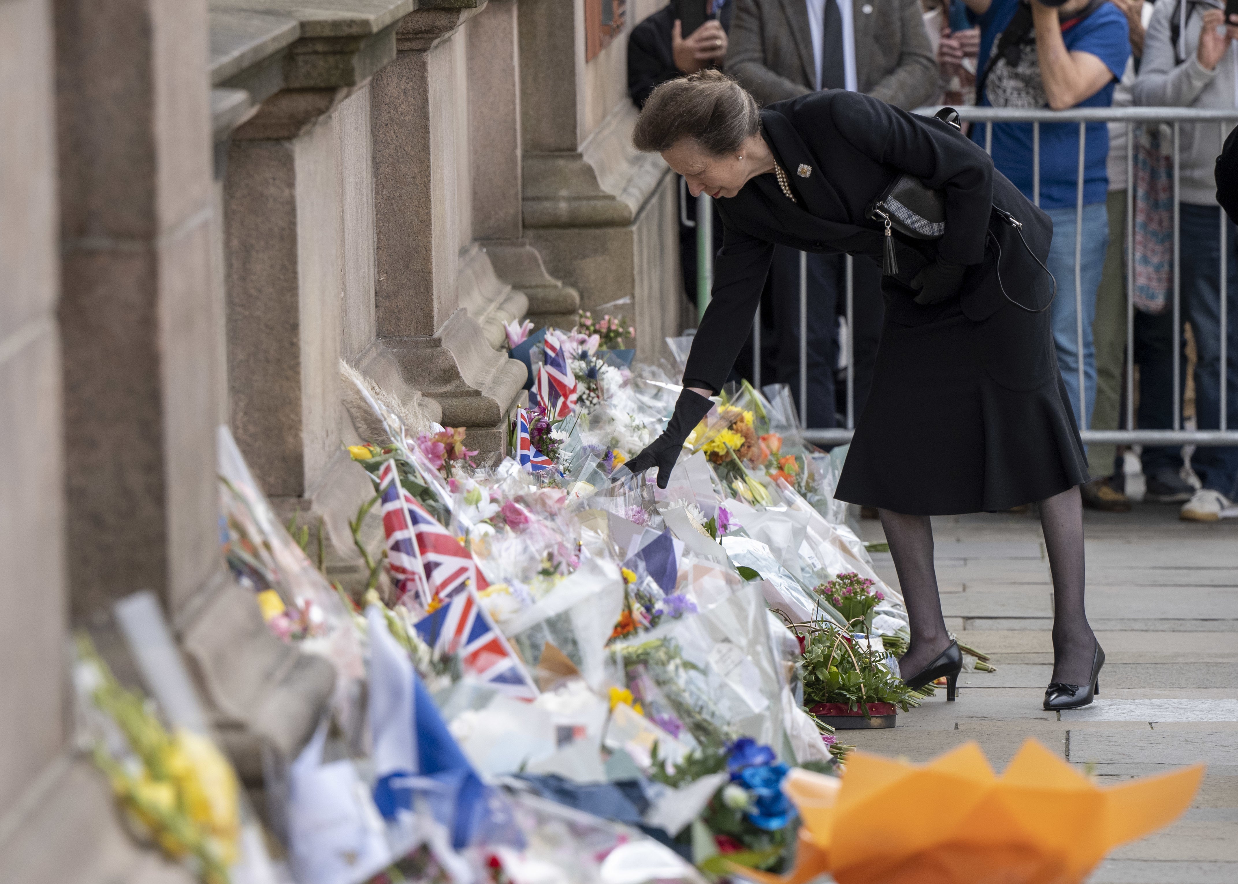 The Princess Royal looks at floral tributes during a visit to Glasgow City Chambers (John Linton/PA)