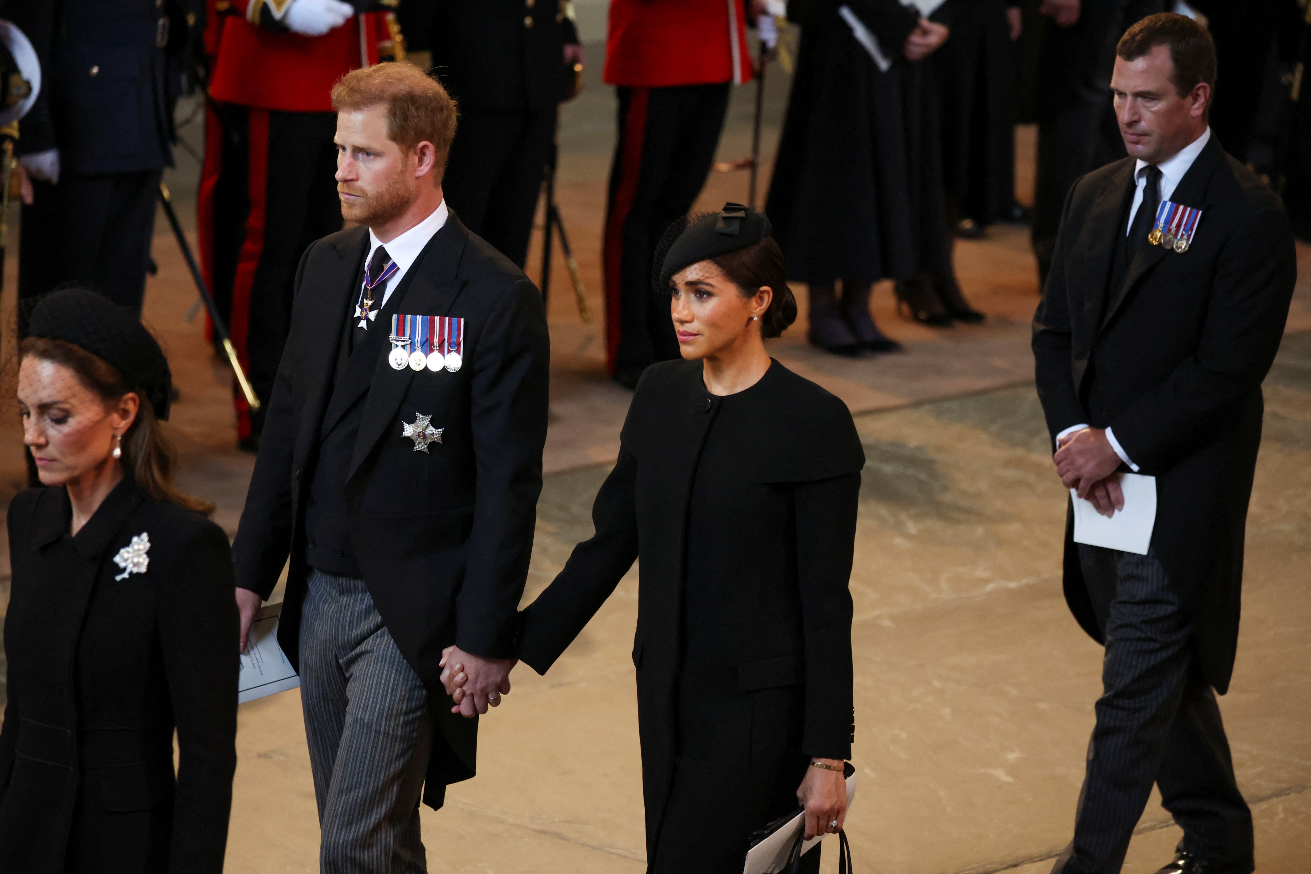 Meghan Markle and Prince Harry held hands as they departed service for Queen Elizabeth II